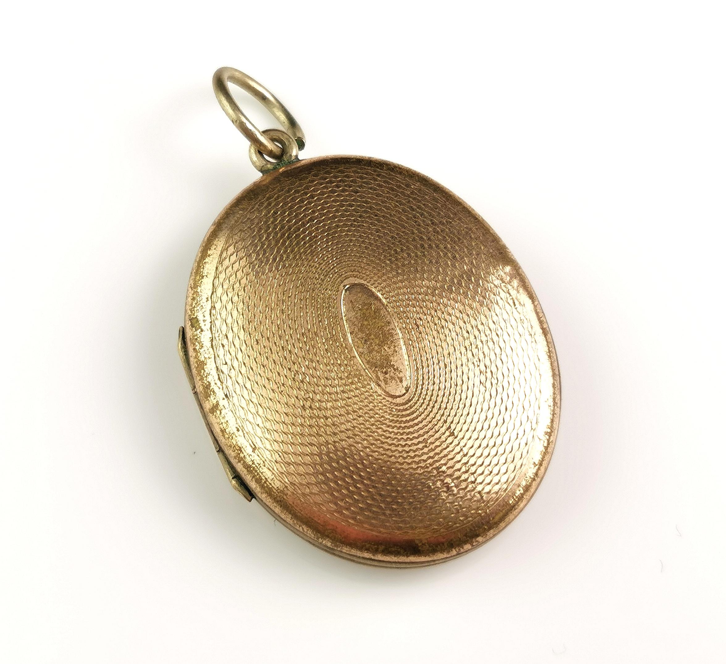 A charming antique Victorian era gilt metal locket pendant.

This girl has some wear and tear but still has so much to give and is perfect for storing your special pictures.

Made from a gilt plated brass it has an attractive engine turned design