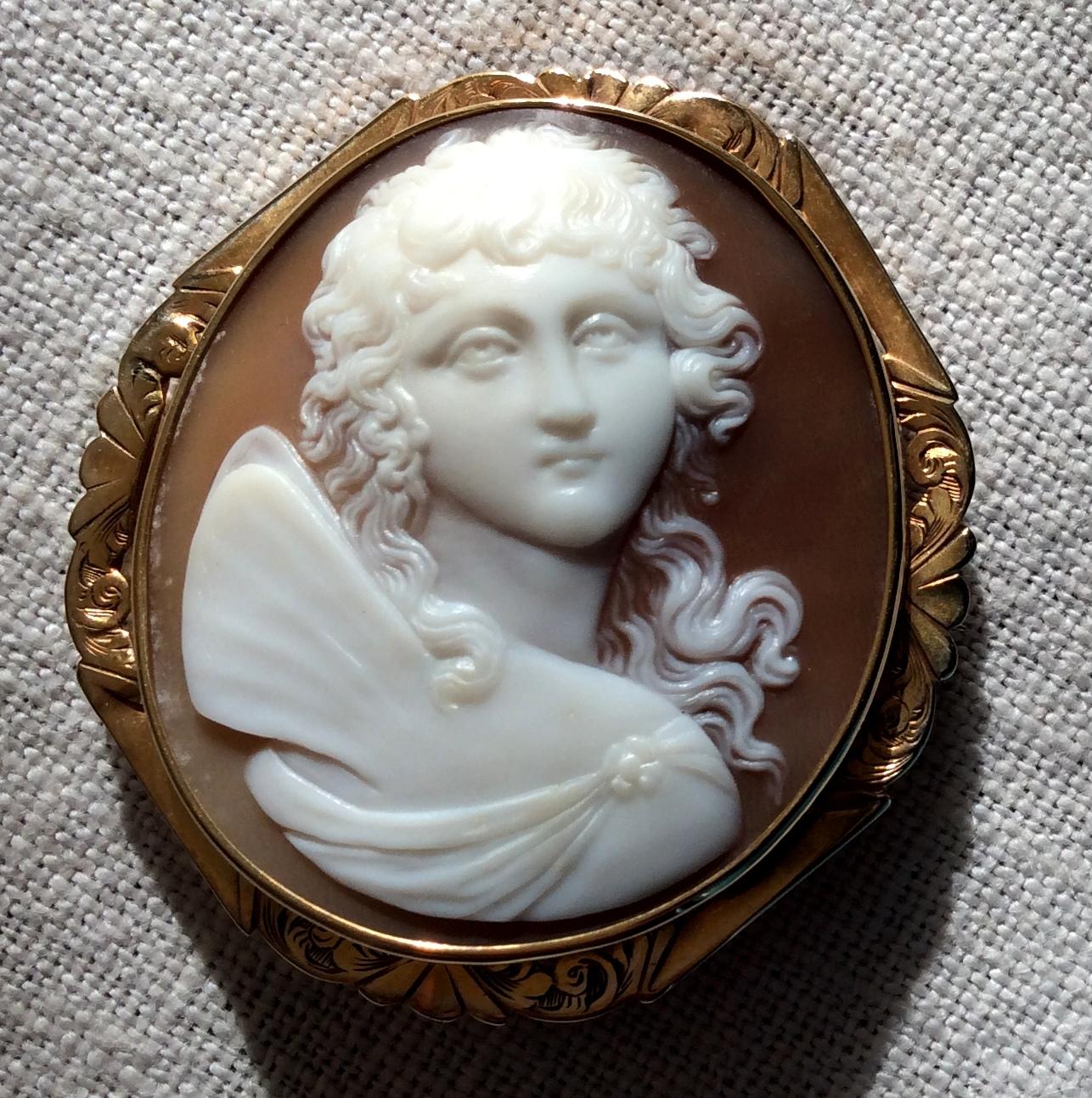 Excellent Quality high-relief shell cameo brooch in a gold mount, circa 1860. The subject is Psyche, the wife of Eros and Goddess of Soul. This is a rare cameo because it depicts Psyche carved in front face.  The carving is amazing, you can see all