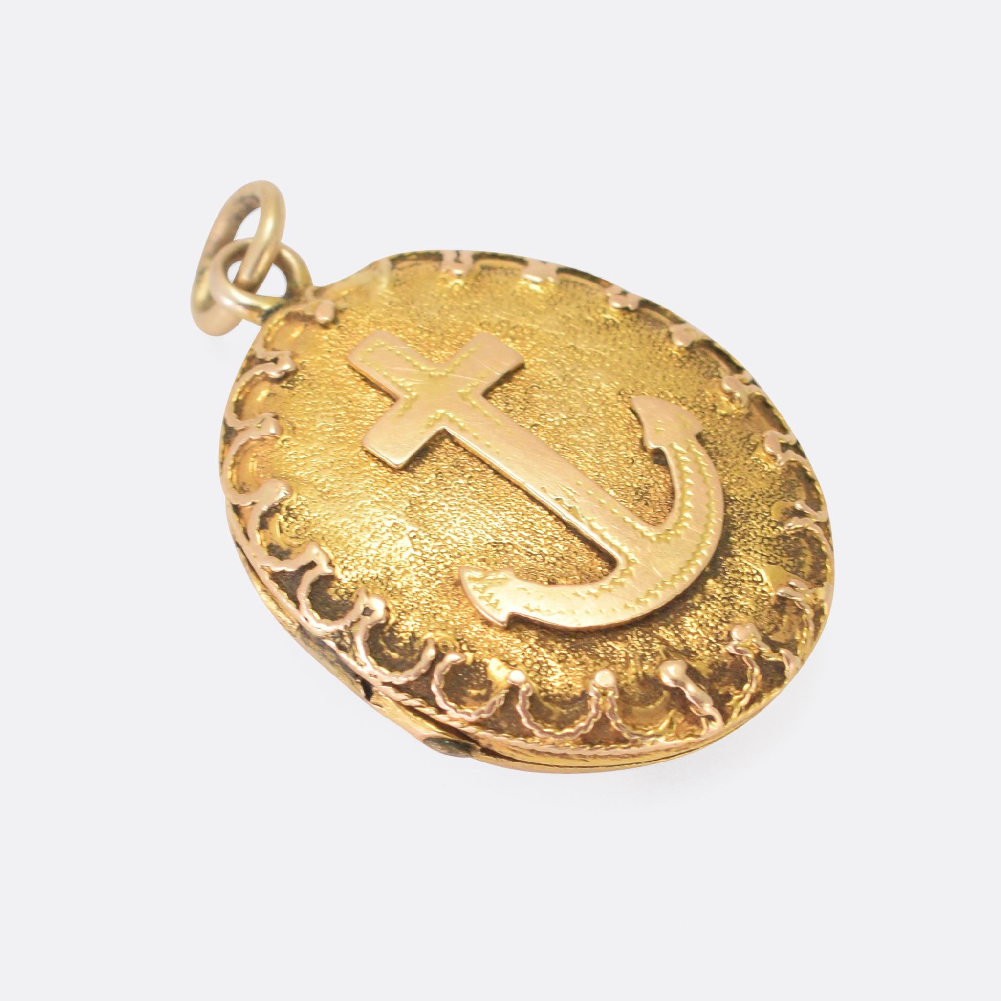 A cool antique oval locket dating from the late Victorian era. The front is furnished with an anchor motif on a finely textured background and all within an ornate applied ropework border. It's crafted in high carat yellow gold, and opens to reveal
