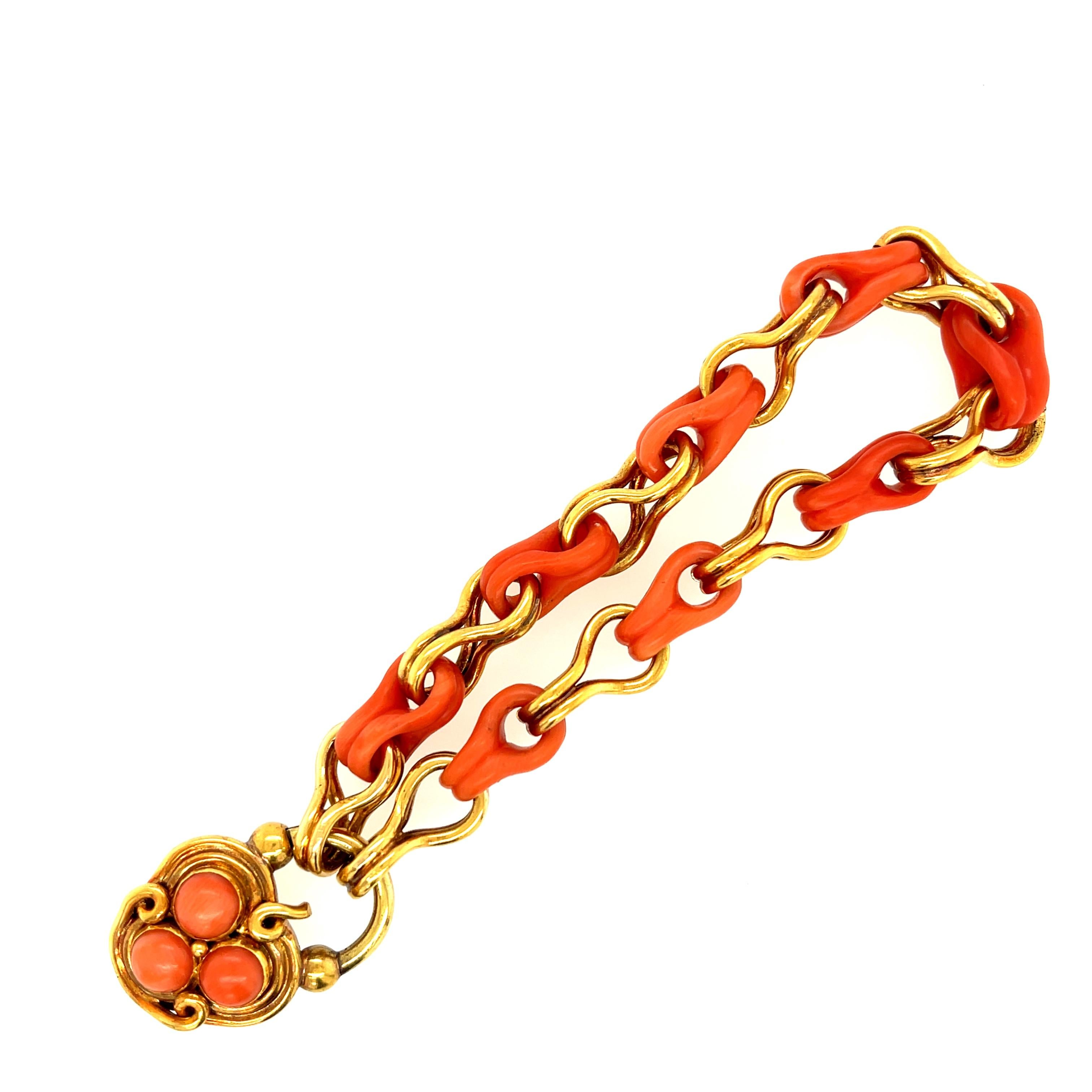 A rare and unusual Victorian coral gold bracelet with a coral set padlock claps. The gold tests for 18k gold. The chain bracelet is made up of alternating gold links with matching carved coral links, the padlock locket opens to secure the bracelet