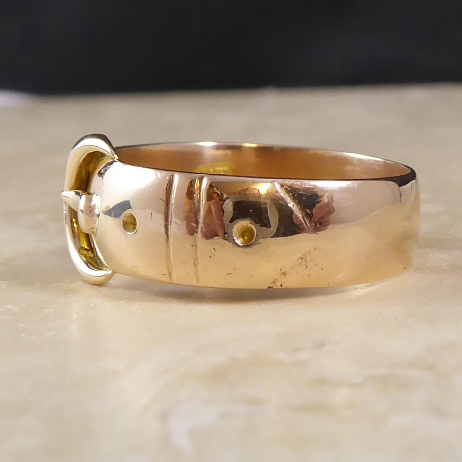 Crafted in 9ct rose gold, this lovely antique buckle ring was hallmarked at the collectible Chester Assay Office in 1895.  The buckled belt was a popular design for gold band rings during the Victorian era.  This lovely example measures approx.