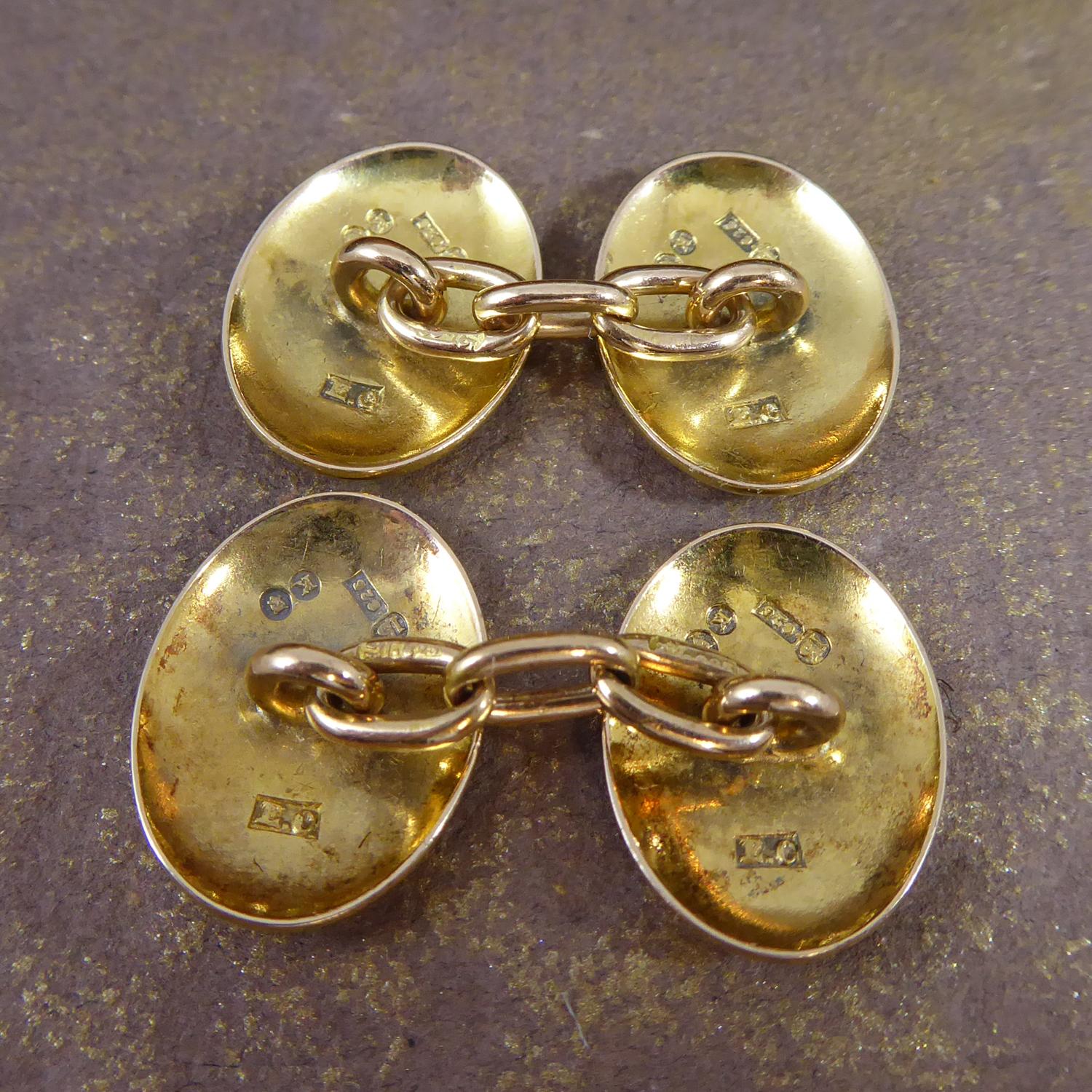 Victorian cufflinks crafted in 15ct gold in London 1885.  The cufflinks are extravagantly hand engraved with a floral pattern to both sides of the cufflink.  Connected by oval gold chain stamped with the marks for 15ct gold.  Oval in shape and