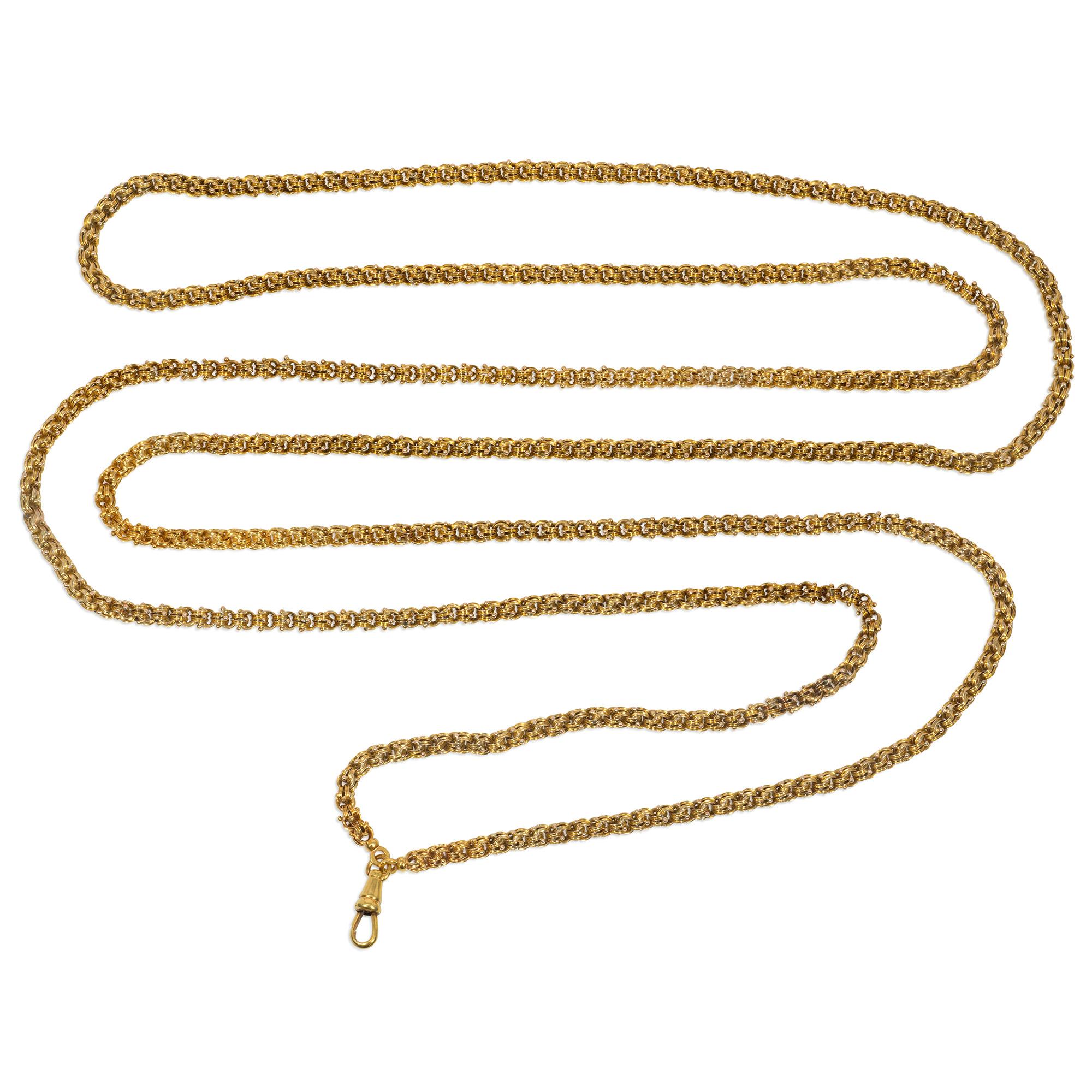 An antique Victorian period gold long guard chain comprised of handmade, interlocking reeded and beaded links, in 15k.  England. (French swivel hinged bale in 18k.)  Gorgeously substantial gauge, 67