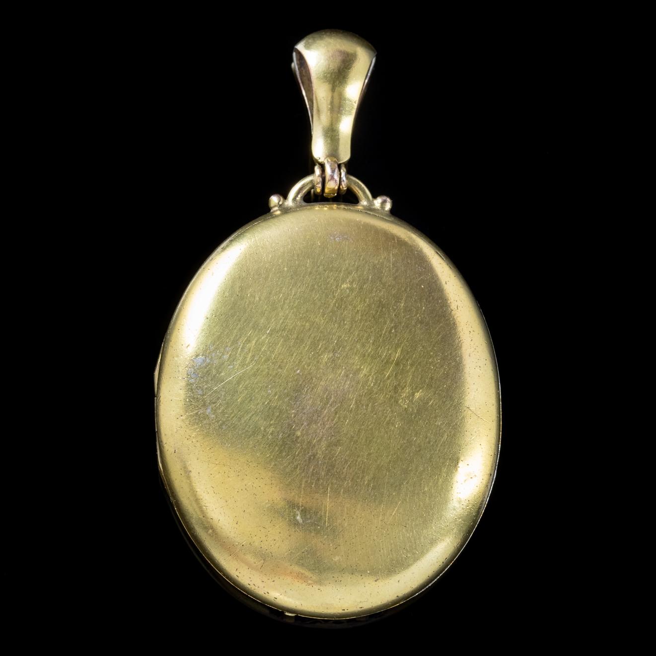 This exquisite large antique Victorian Locket is set in Silver and gilded in Yellow Gold with a decorative strip down the front which has been beautifully engraved. 

The piece opens and closes securely and is complete with rims and windows inside