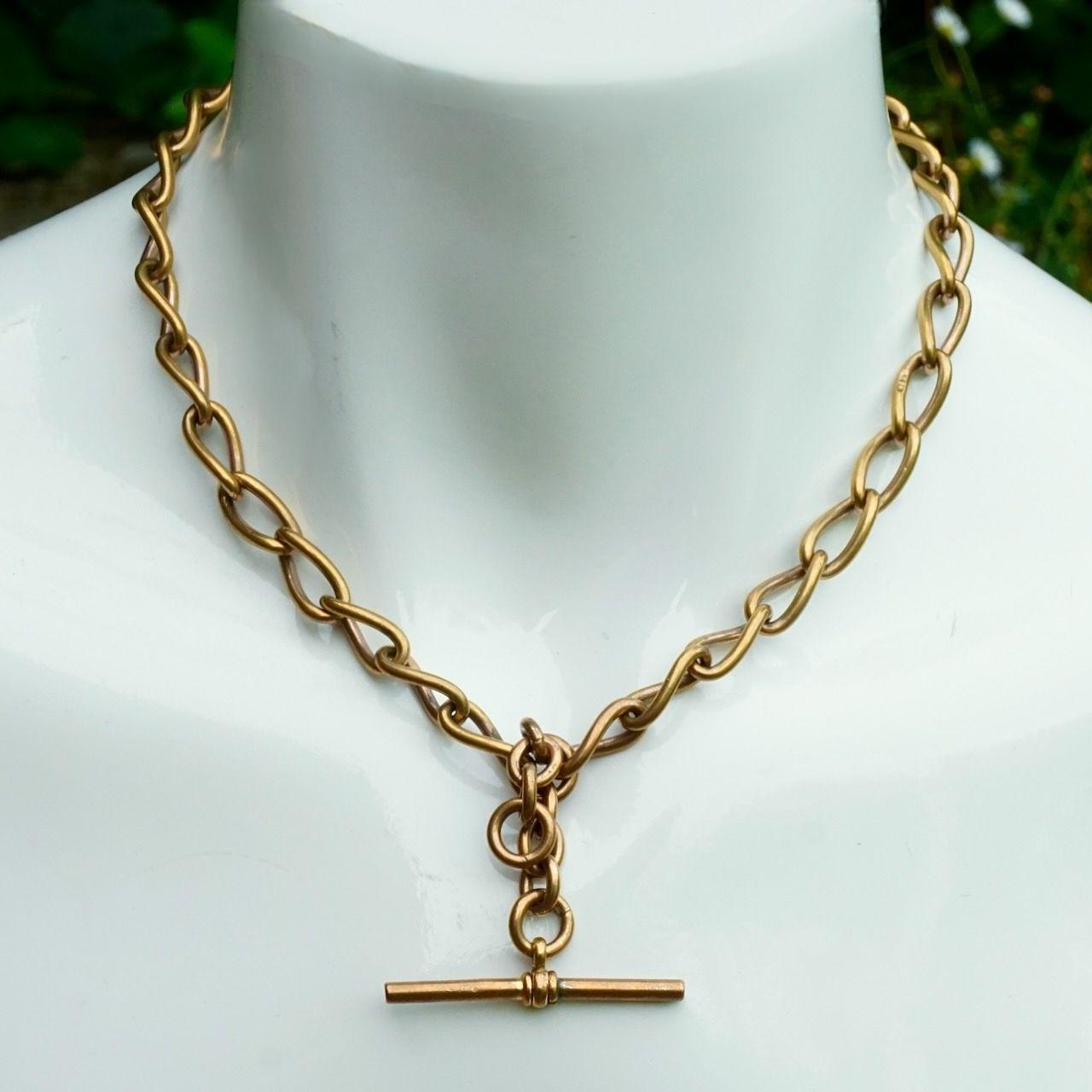 Antique Victorian gold gilt metal Albert watch chain with T bar, stamped T + H.  It has a coppery hue.

The T bar was originally used to go through a buttonhole. The dog clip was attached to a watch.

Measuring length 42 cm / 16.5 inches, a very