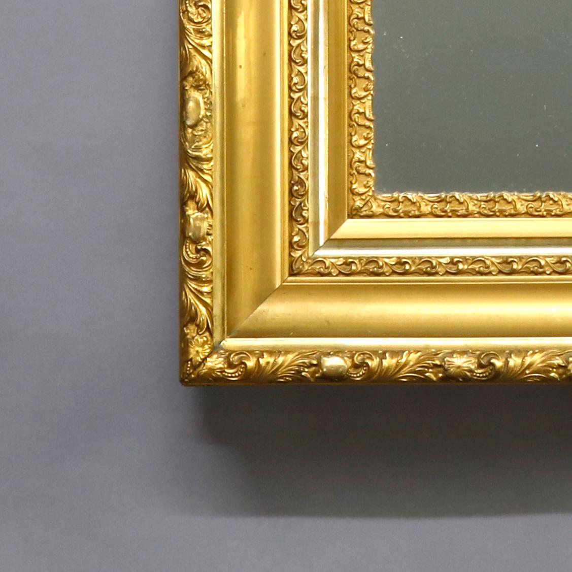 An antique Victorian wall mirror offers classical foliate decorated gold giltwood frame, circa 1890

Measures: 26.25