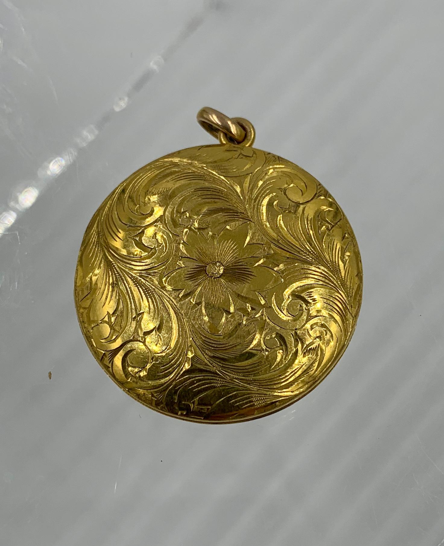 A GORGEOUS VICTORIAN BELLE EPOQUE PICTURE LOCKET PENDANT IN WARM 10 KARAT GOLD WITH BEAUTIFUL FLOWER AND ACANTHUS LEAF MOTIF ENGRAVING ON THE FRONT AND AN ENGRAVED MONOGRAM ON THE REVERSE.   THE LOCKET IS A PERFECT SIZE - 1 1/4 INCHES IN
