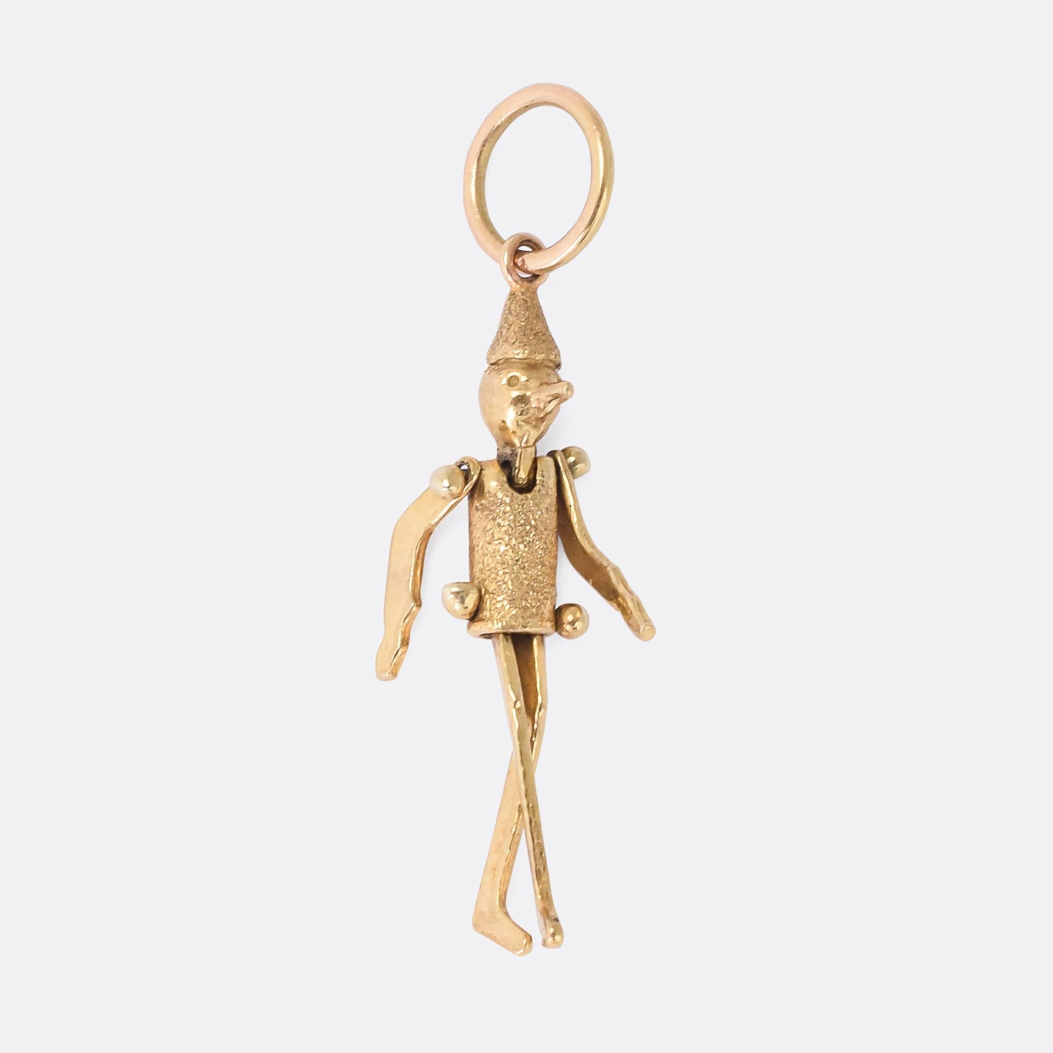 A charming antique Pinocchio in 15 karat gold. His arms and legs are fully articulated and jiggle around as it's worn. The 1940 Disney film adaptation raised Pinocchio to the cultural icon status, but the story was first penned by Carlo Collodi in