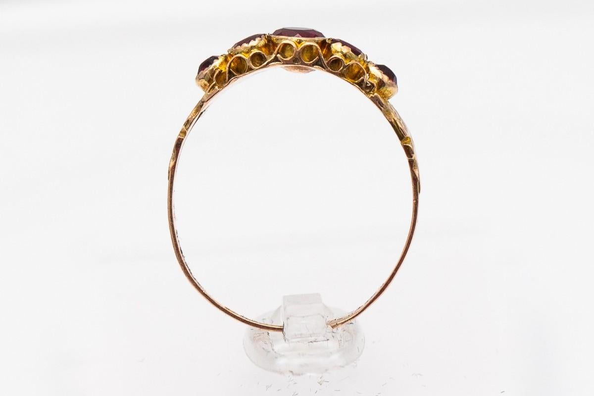 Round Cut Antique Victorian gold ring with garnets, Great Britain, circa 1915.