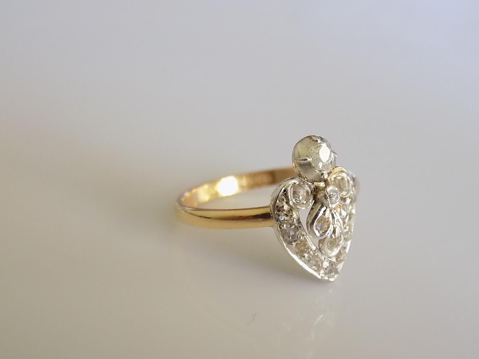 A Lovely Victorian old cut Diamond Heart ring. The stones in Silver setting on later 18 Carat Gold shank. English origin. Rare.
Size J UK, 5 US.
Height of the face 13.5mm.
Weight 2.1gr.
The shank with full London hallmark for 18 Carat Gold.
The ring