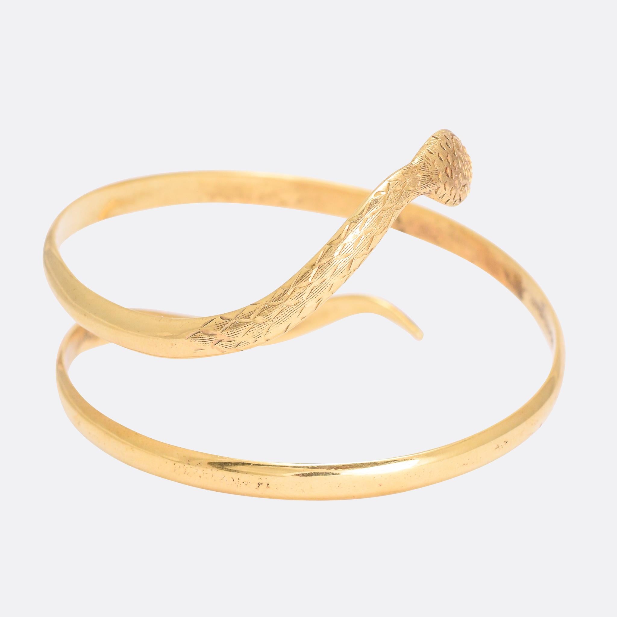 A cool Victorian coiled snake bangle in 9k gold. It dates from the late 19th Century, circa 1880, with hand-chased detailing to the head and neck. It's a good quality, substantial piece, and remains in great condition nearly 150 years