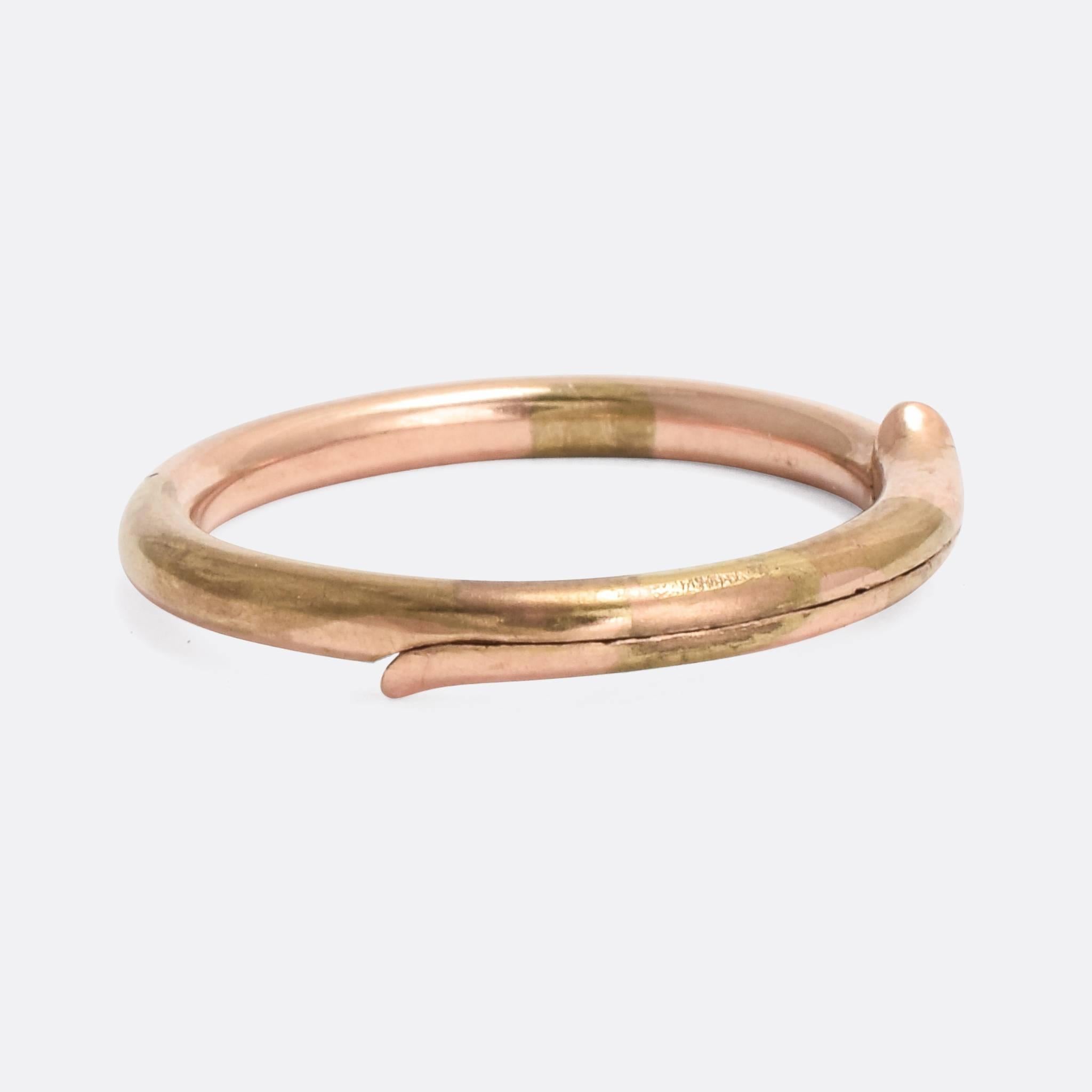 An unusual antique split ring modelled in 9 karat gold. The edges of the split flare out in a sort of snake-like way. It dates from the late Victorian era, circa 1880 - perfect for holding your collection of charms.

MEASUREMENTS 
22.8mm