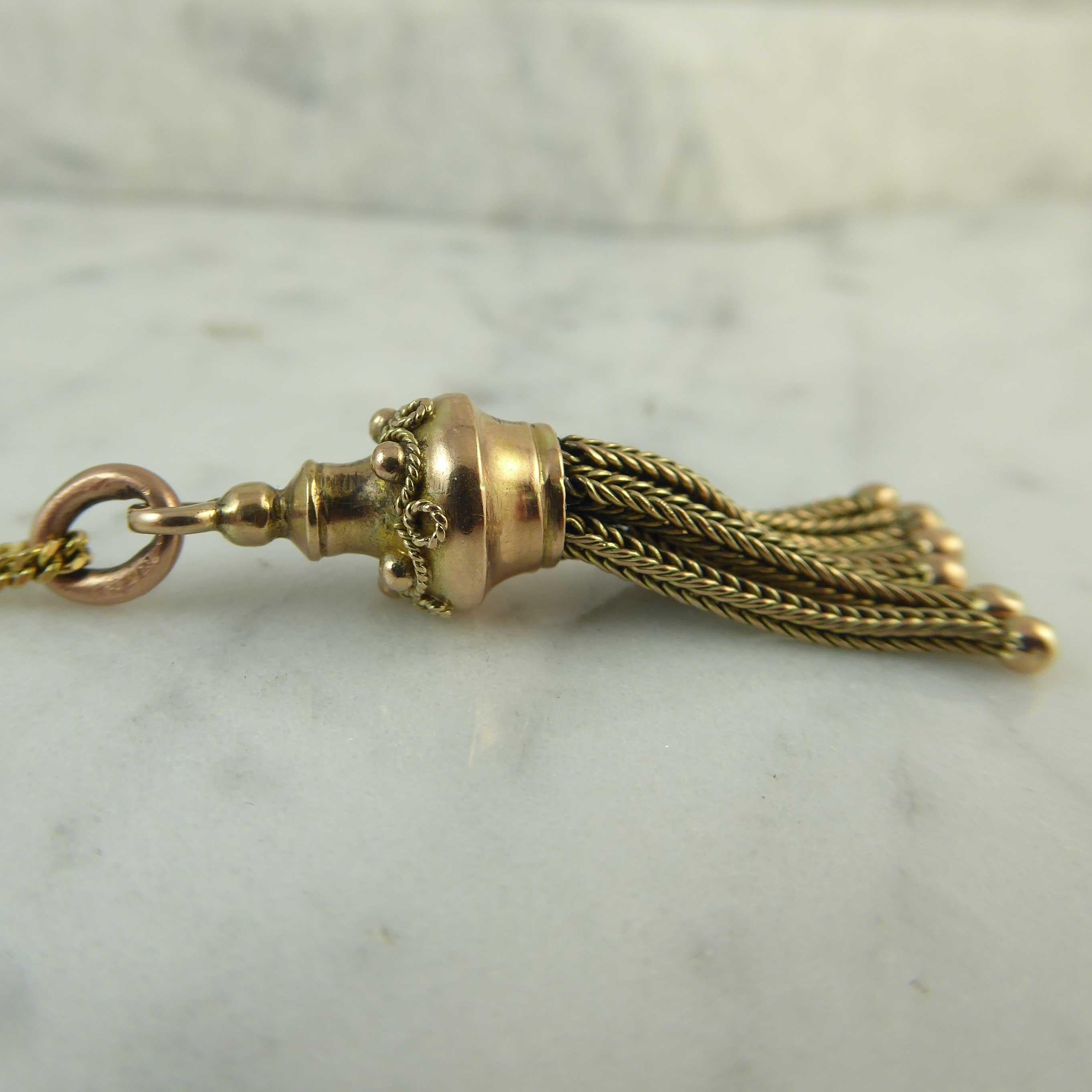Late Victorian yellow gold tassel pendant suspending from a yellow gold chain 22