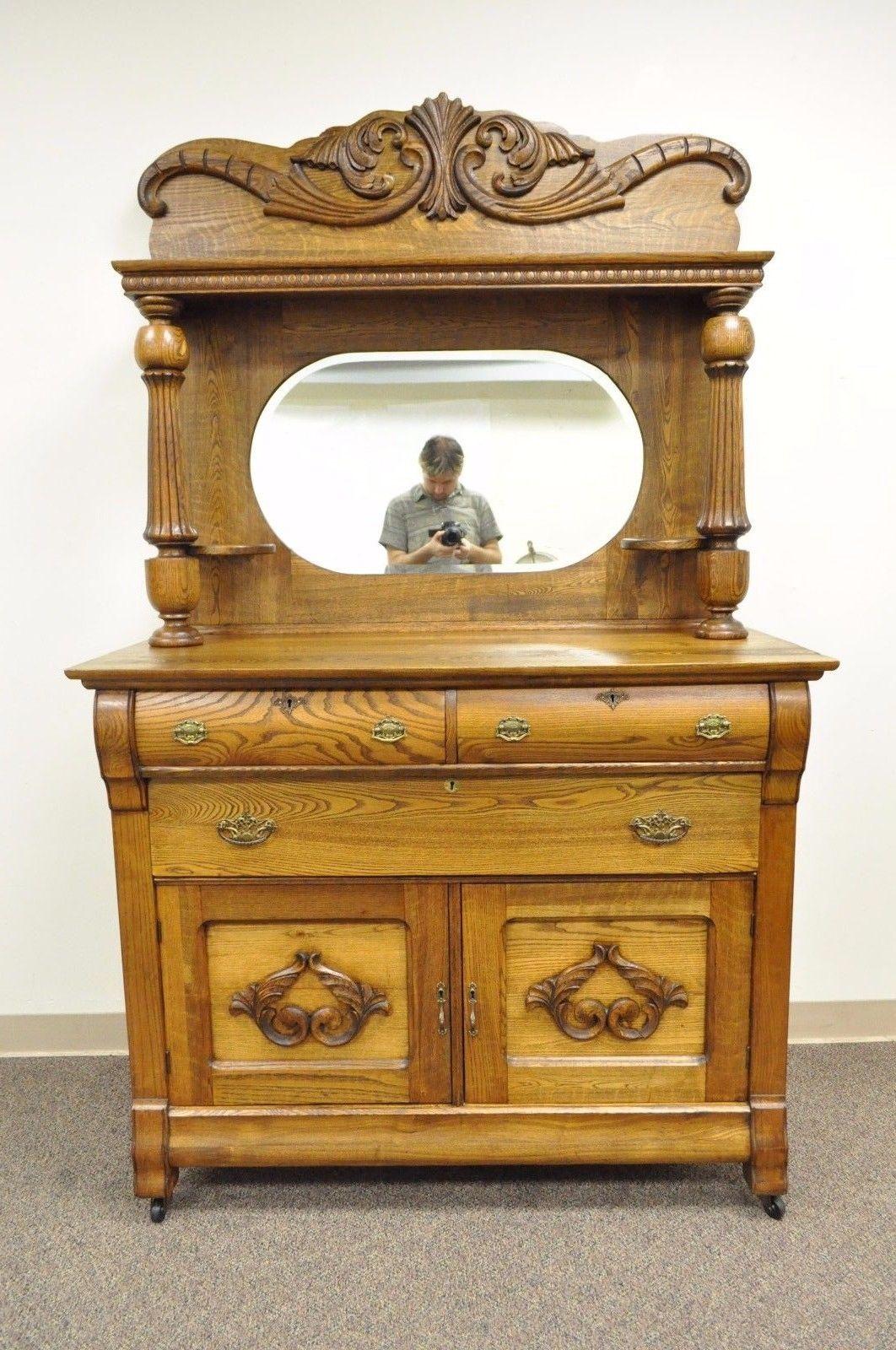 Antique golden quartered oak Victorian mirror back sideboard. Item features beautiful oak wood grain throughout, two part construction, beveled glass mirror, applied carved acanthus pediment, three dovetail constructed green felt lined drawers,