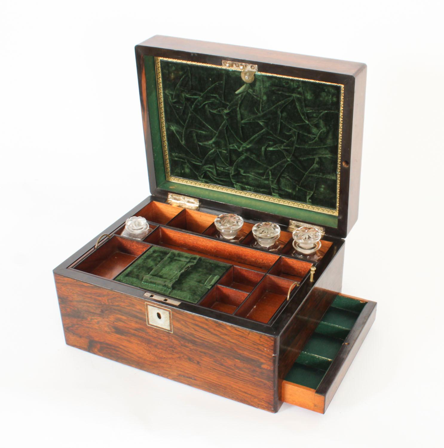 This is a magnificent antique Victorian Gonçalo Alves table top Vanity Box, circa 1860 in date.
 
 The fitted interior reveals a lift-out compartment tray, dressed with a green velvet centre and three scent bottles.

The top features a green leather
