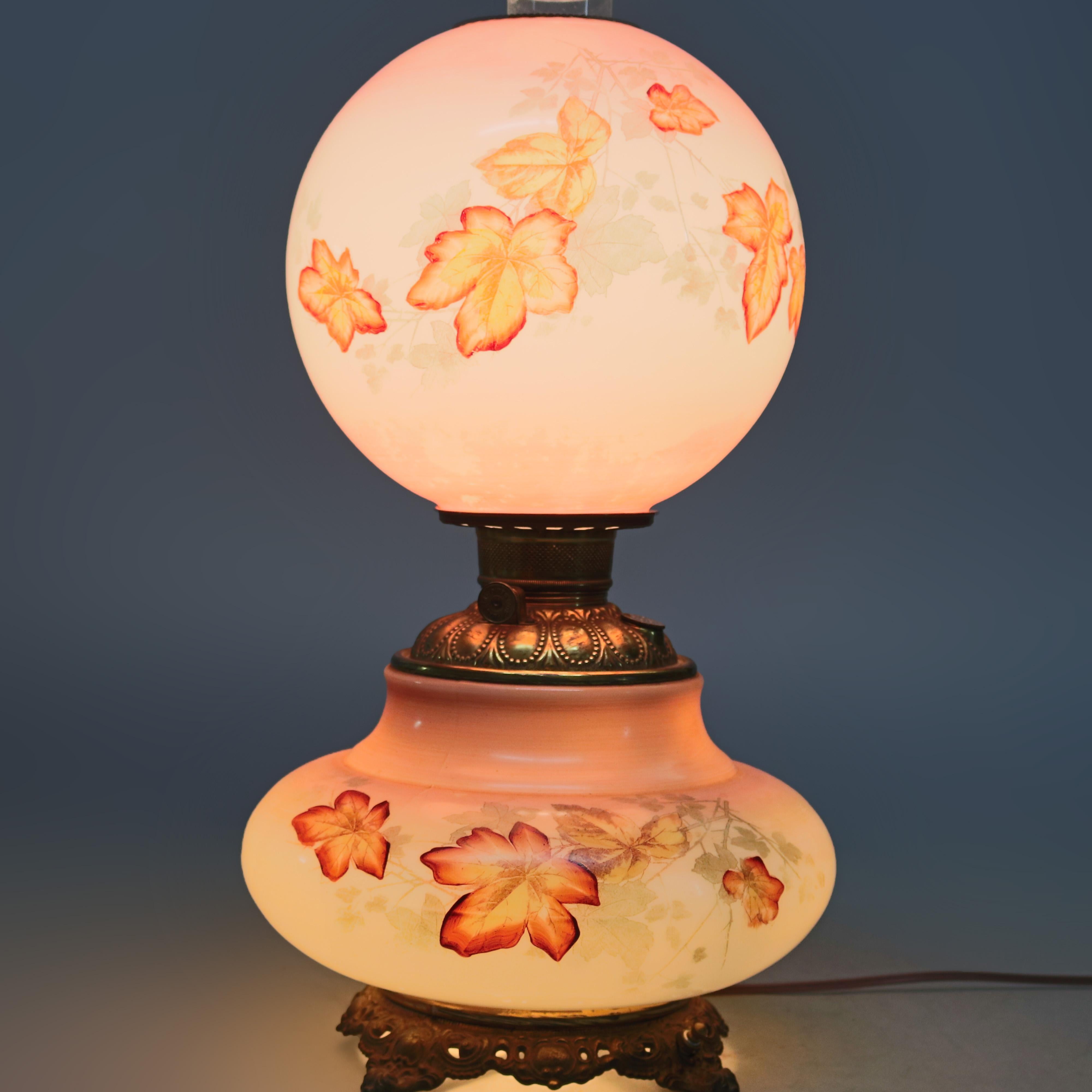 An antique Victorian gone with the wind parlor lamp offers shade and base hand painted with fall leaves, electrified, circa 1890

Measures: 21