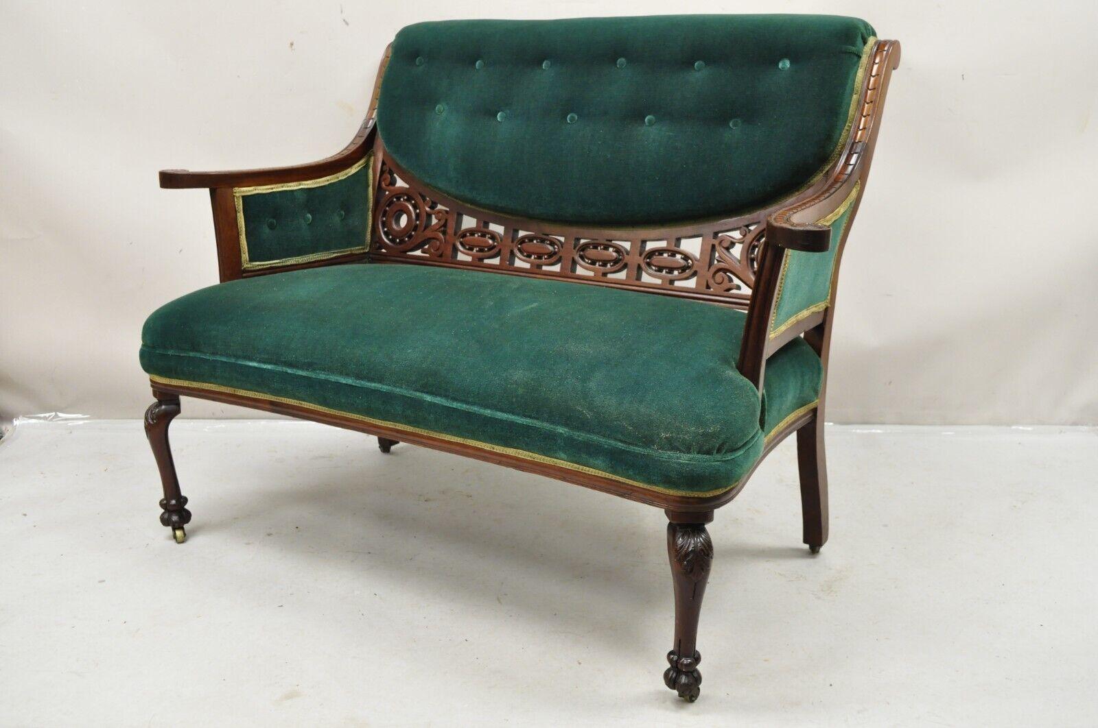 Antique Victorian Green Mohair Fretwork Carved Mahogany Parlor Loveseat Settee. Circa  Late 19th Century.
Measurements: 35