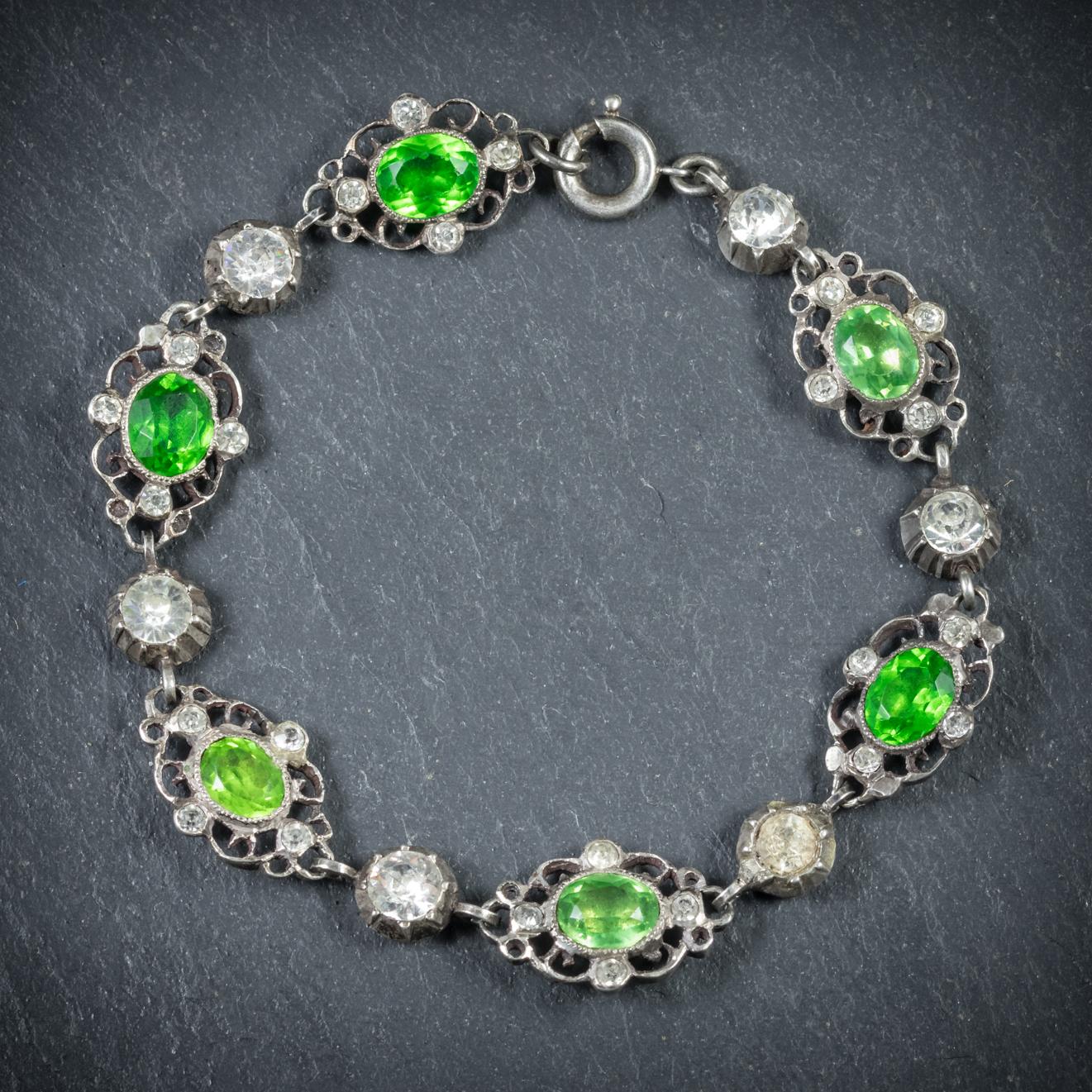This beautiful antique Paste stone bracelet is from the Victorian era, Circa 1900

Decorated with sparkling, white Paste Stones and larger grassy green Pastes that emulate Peridots 
All set in Silver with expert, detailed workmanship displayed