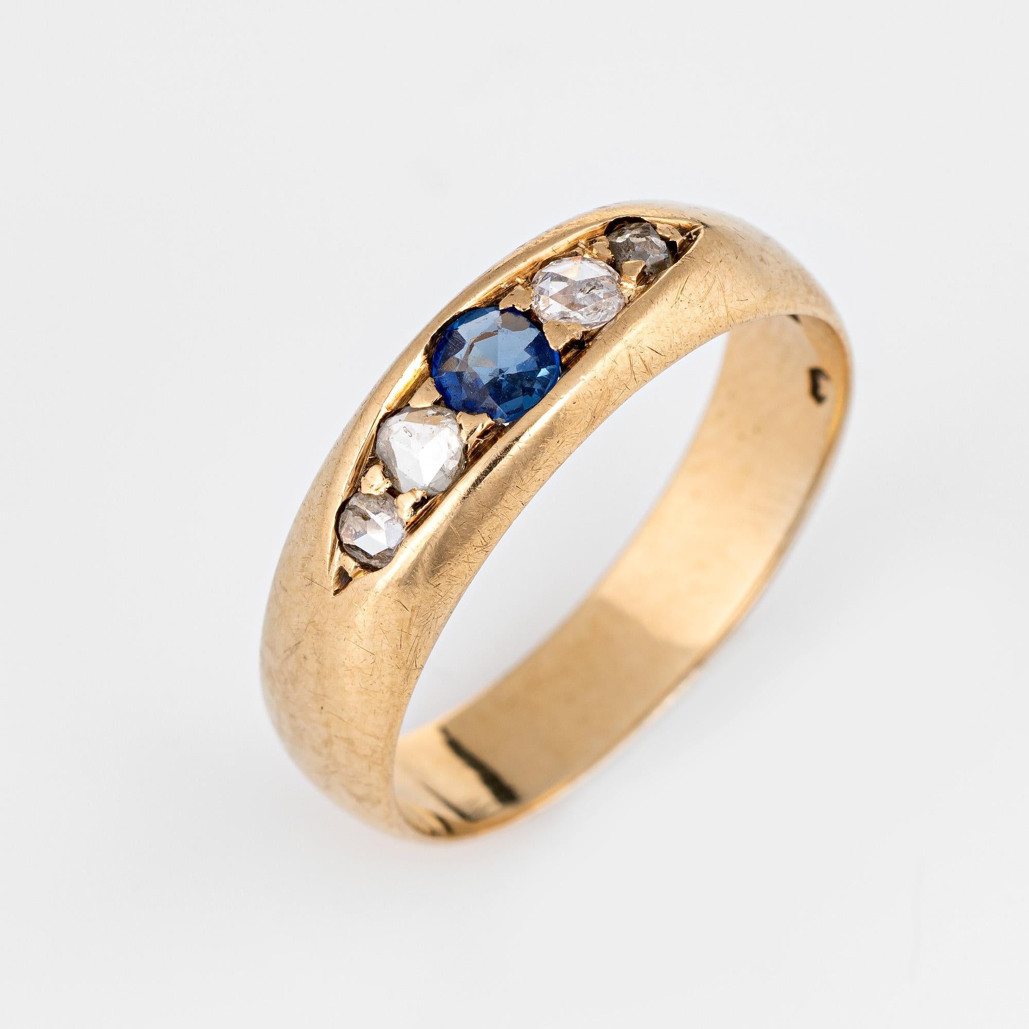 Elegant antique Victorian gypsy band (circa 1880s to 1900s) crafted in 14 karat yellow gold. 

Centrally mounted estimated 0.15 carat blue sapphire is accented with two estimated 0.05 and two estimated 0.03 carat old rose cut diamonds. The total