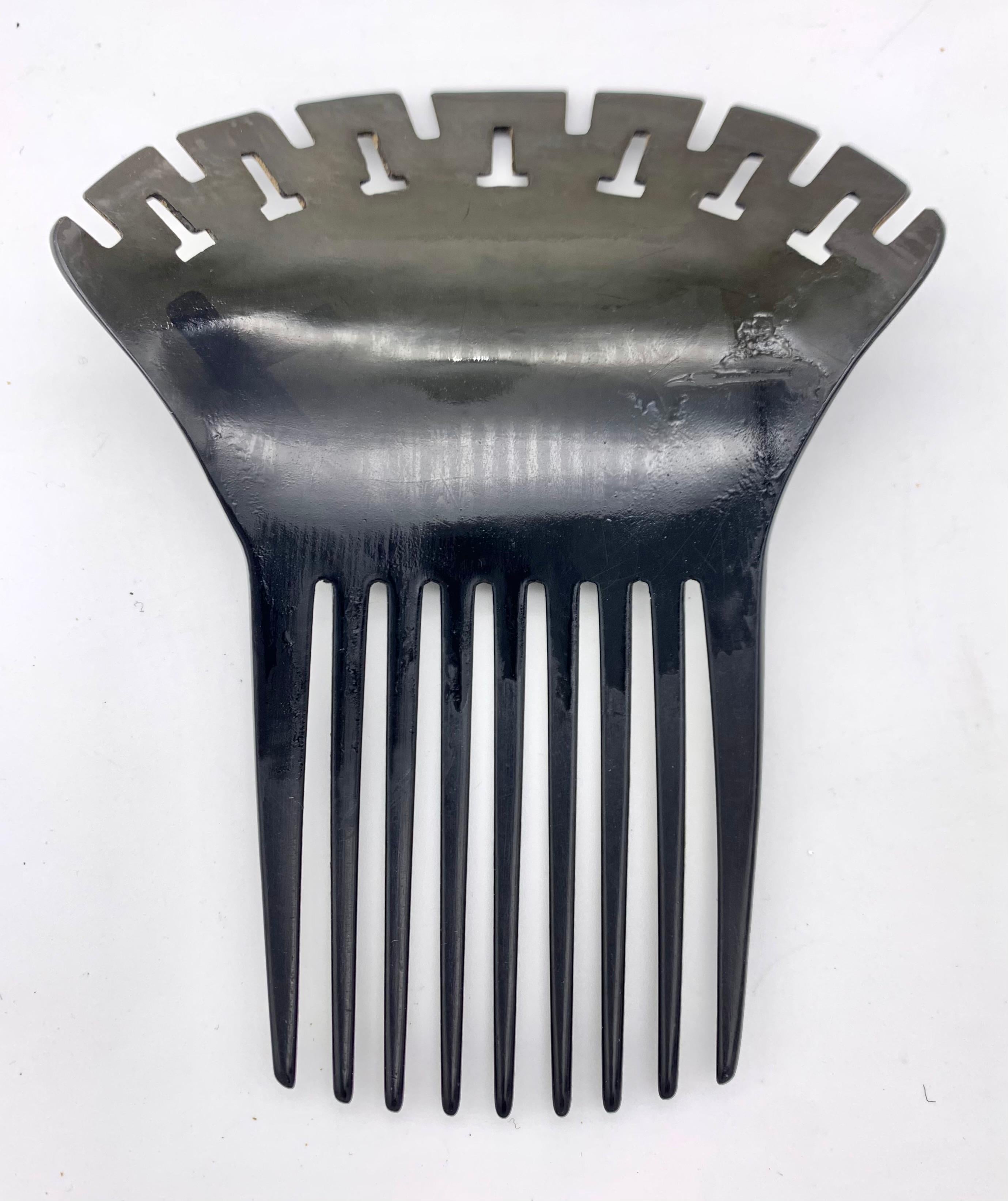 This Victorian vulcanite hair comb is decorated with a Greek Revival Key Pattern ornament. 
Vulcanite, also known as gutta percha, is a natural material made out of rubber. It was popular and widely used for jewellery and vanity objects in the