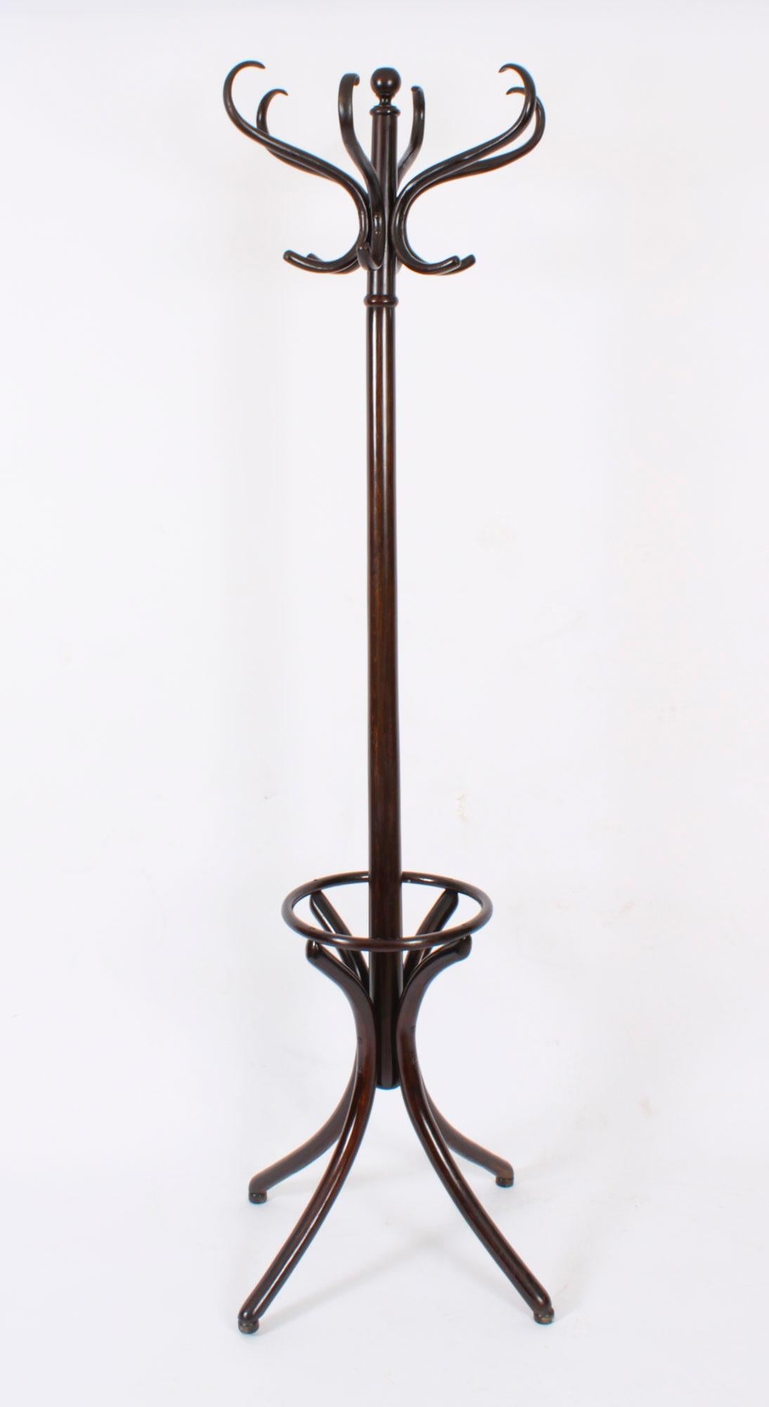 An excellent antique free standing bentwood stained beech coat, hat and stick stand, attributed to Thonet, circa 1890 in date.

It features a central pillaster complete for six  cloaks or hats and a lower rack for sticks and umbrellas.

It is a