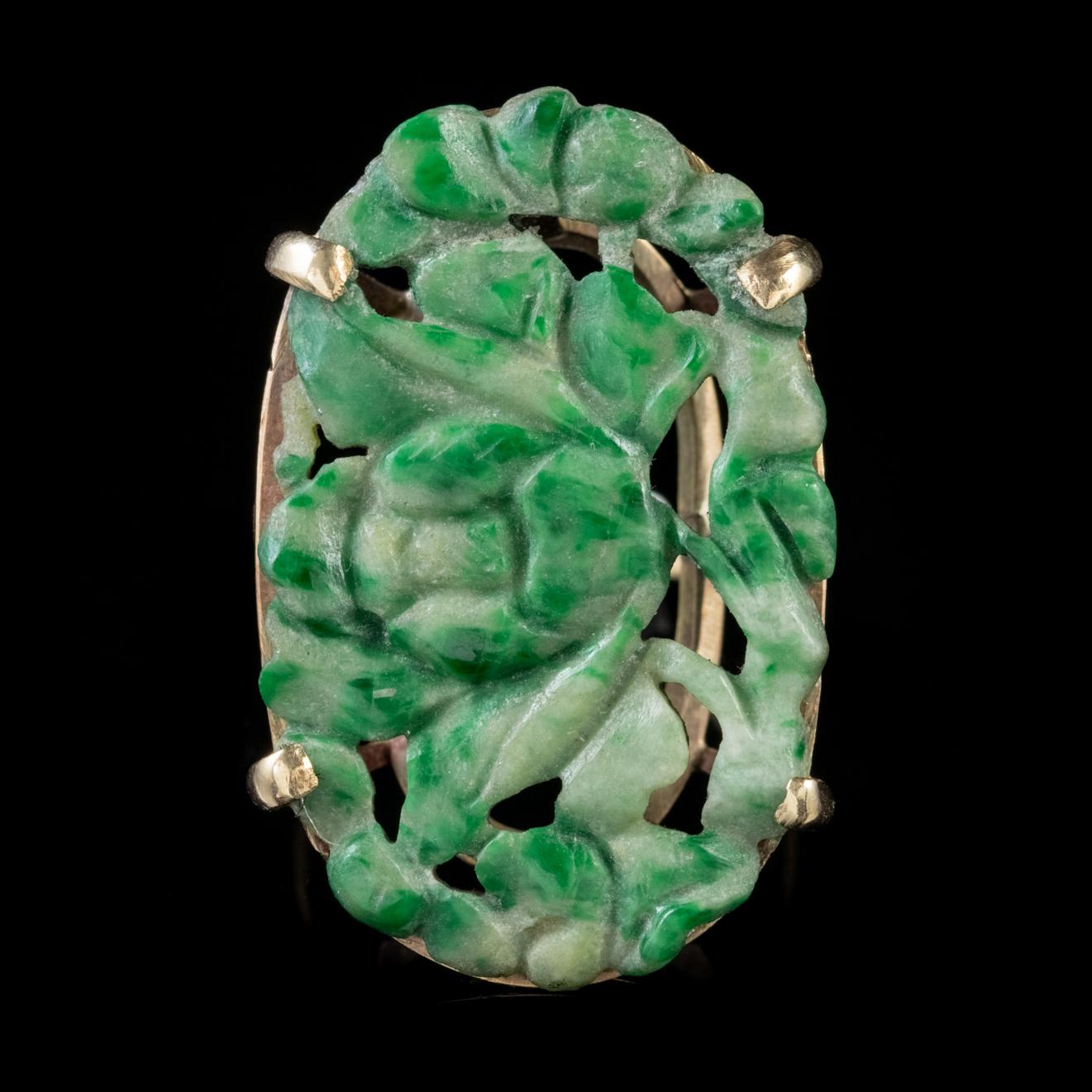 This grand Antique late Victorian ring is set with a large Jade stone which displays beautiful natural colouring and a lovely floral design hand carved by an expert hand. 

Jade is considered the ultimate ‘Dream Stone’ and has been admired in