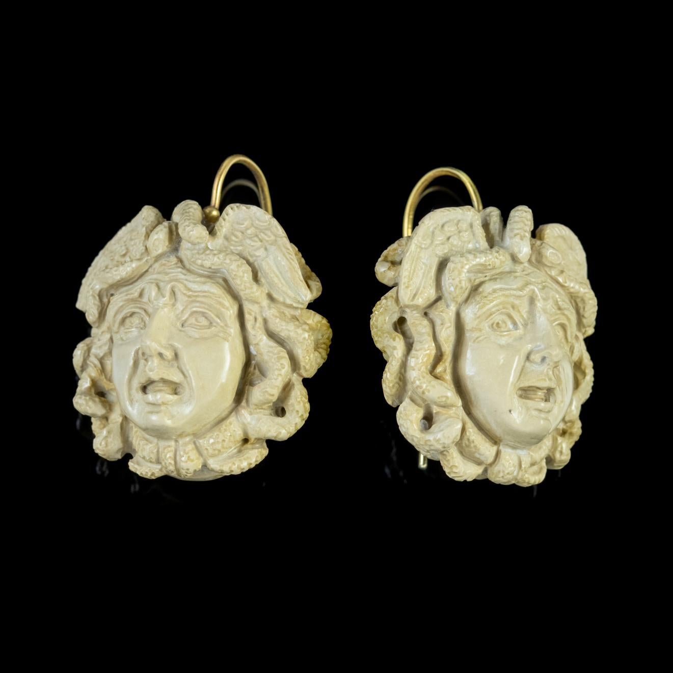 An exquisite pair of antique Victorian earrings depicting the Gorgon Medusa who was known in Greek mythology for her venomous stare which was said to turn any who gazed upon her to stone. 

Each earring is hand carved from Volcanic Lava stone