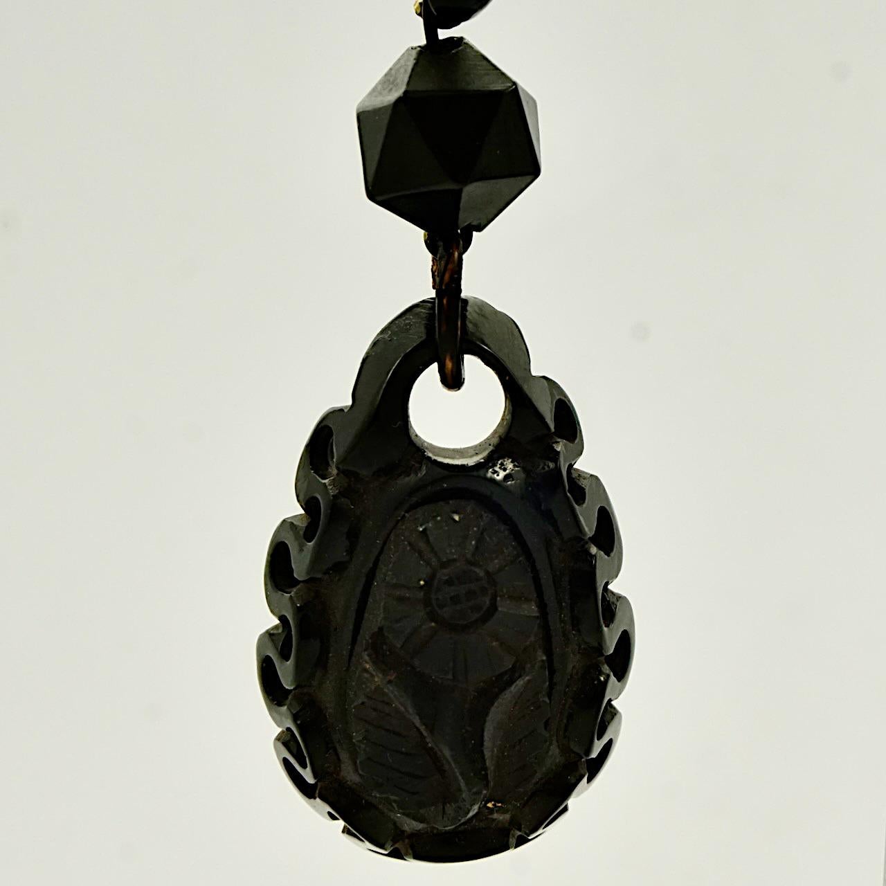 Antique Victorian hand carved Whitby Jet earrings with a lovely flower design, and gold tone hooks. Measuring, not including the hooks, length 4.5 cm / 1.77 inches by width 2 cm / .78 inch. The earrings are in very good condition. There is wear to