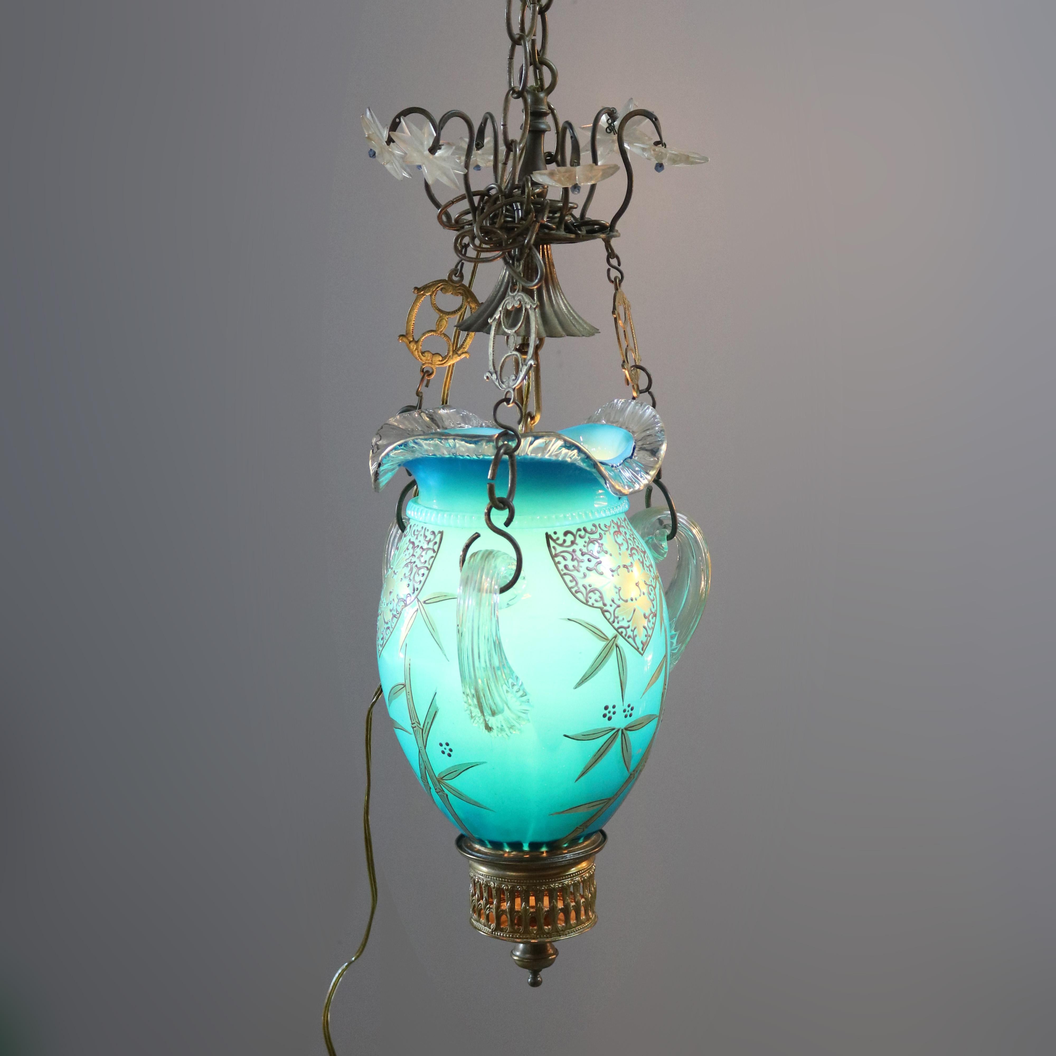 An antique Victorian pendant light offers blue cased art glass construction with hand gilt foliate decoration, elements of Gothic, circa 1890. 

Measures: 24