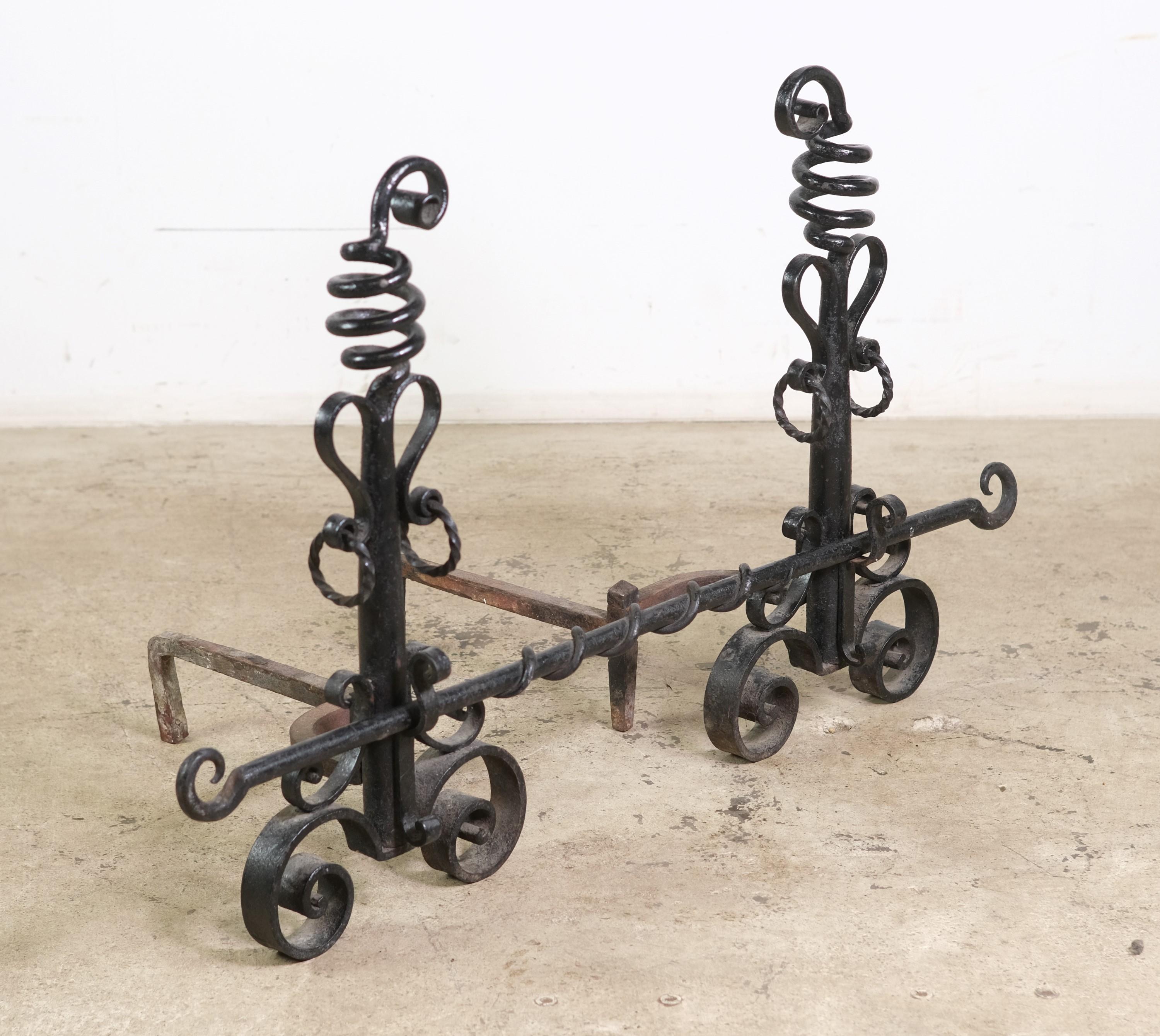 Black painted hand wrought iron andirons with spiral and coil motifs. The cross bar is included. Please note, this item is located in our Scranton, PA location.
