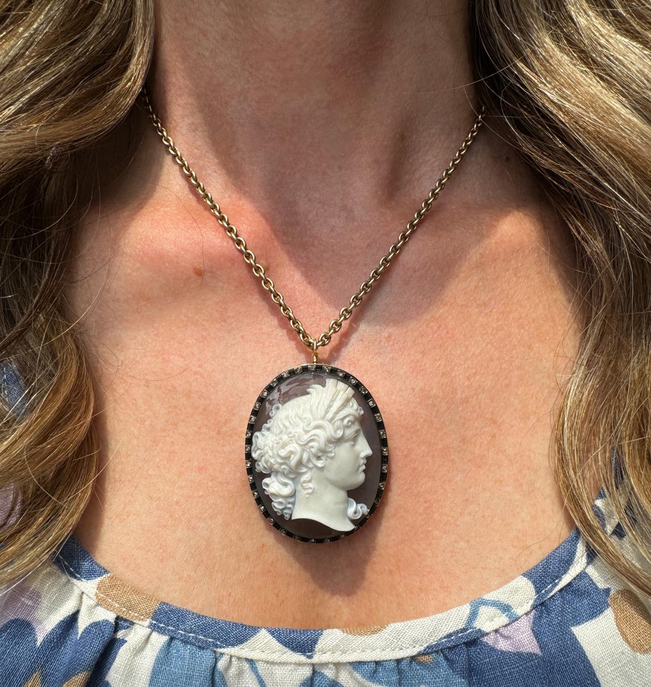 This stunning late 19th century agate cameo depicts Demeter in profile, with wavy upswept hair wearing a crown of barley, symbolizing her dominion over the the earth's fertility. The agate was masterfully carved in high relief using the natural