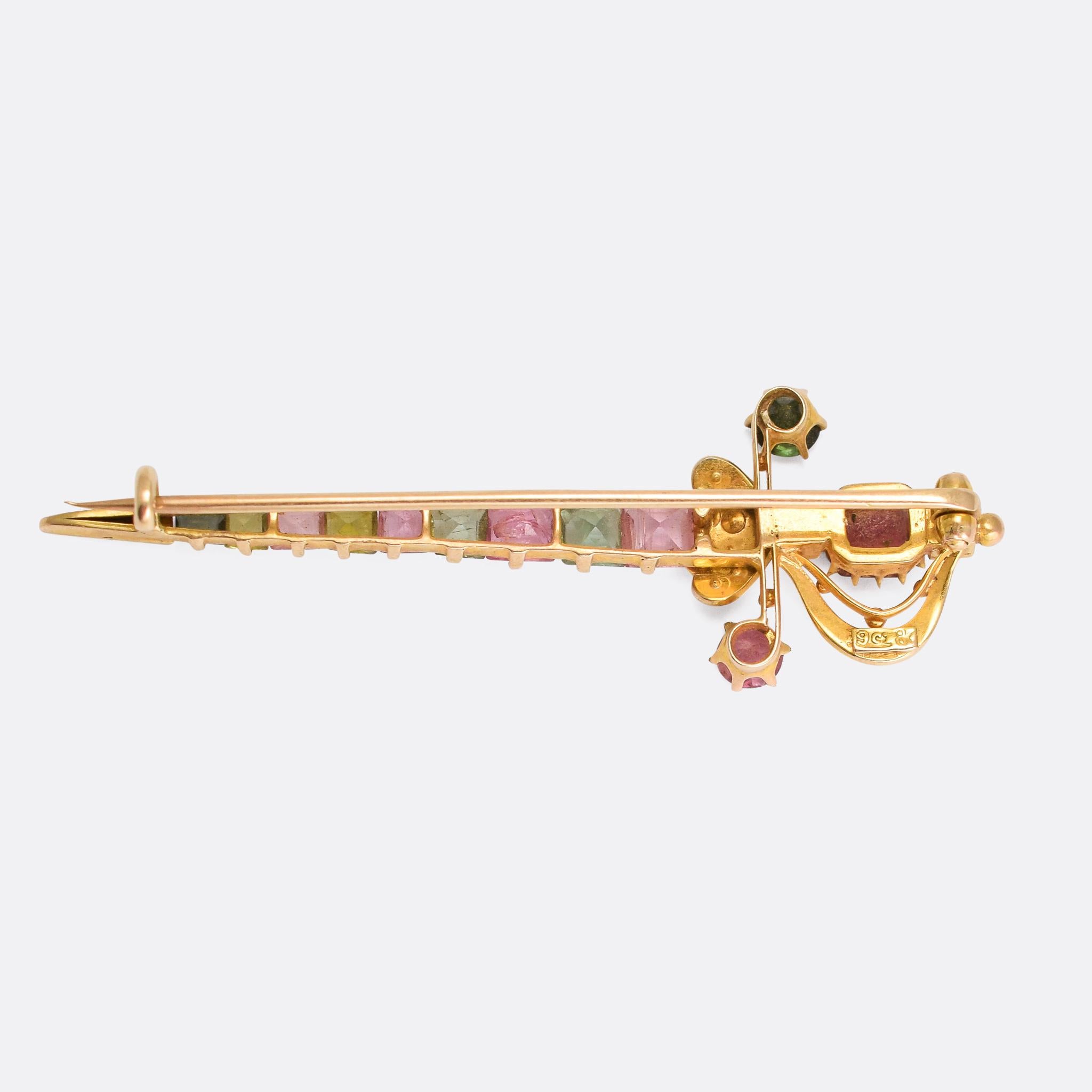 An incredible antique harlequin brooch modelled as a sword, and set with a colourful array of gemstones. The goldwork is exceptional, and the piece remains in excellent condition. Stones include pearl, topaz, tourmaline, peridot and spinel. The