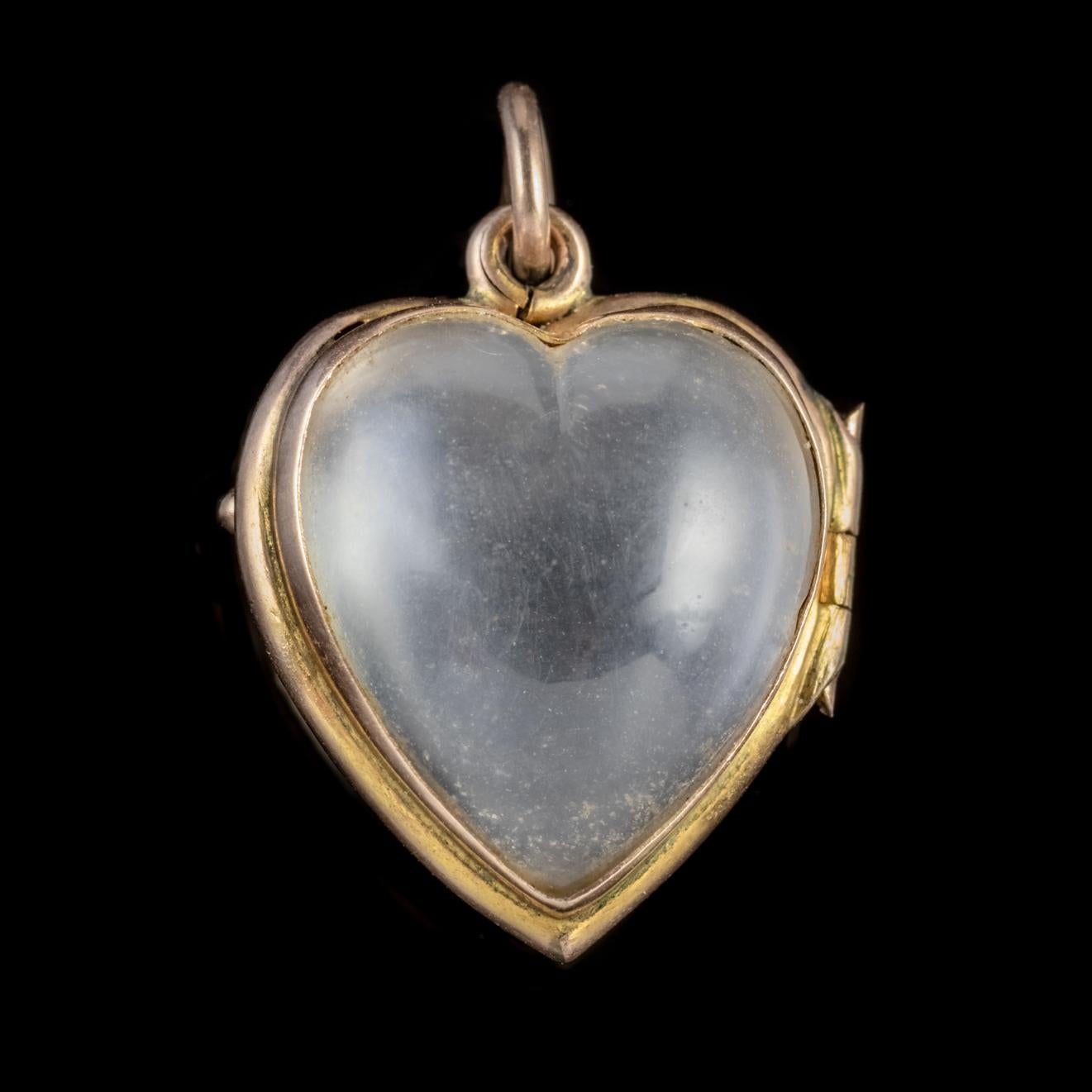 A delightful antique Victorian heart locket set with two lovely smooth Pools of light Rock Crystal hearts which open up allowing a photograph or lock of hair to be secured within and viewed through the transparent stones which magnify it. 

Pools of
