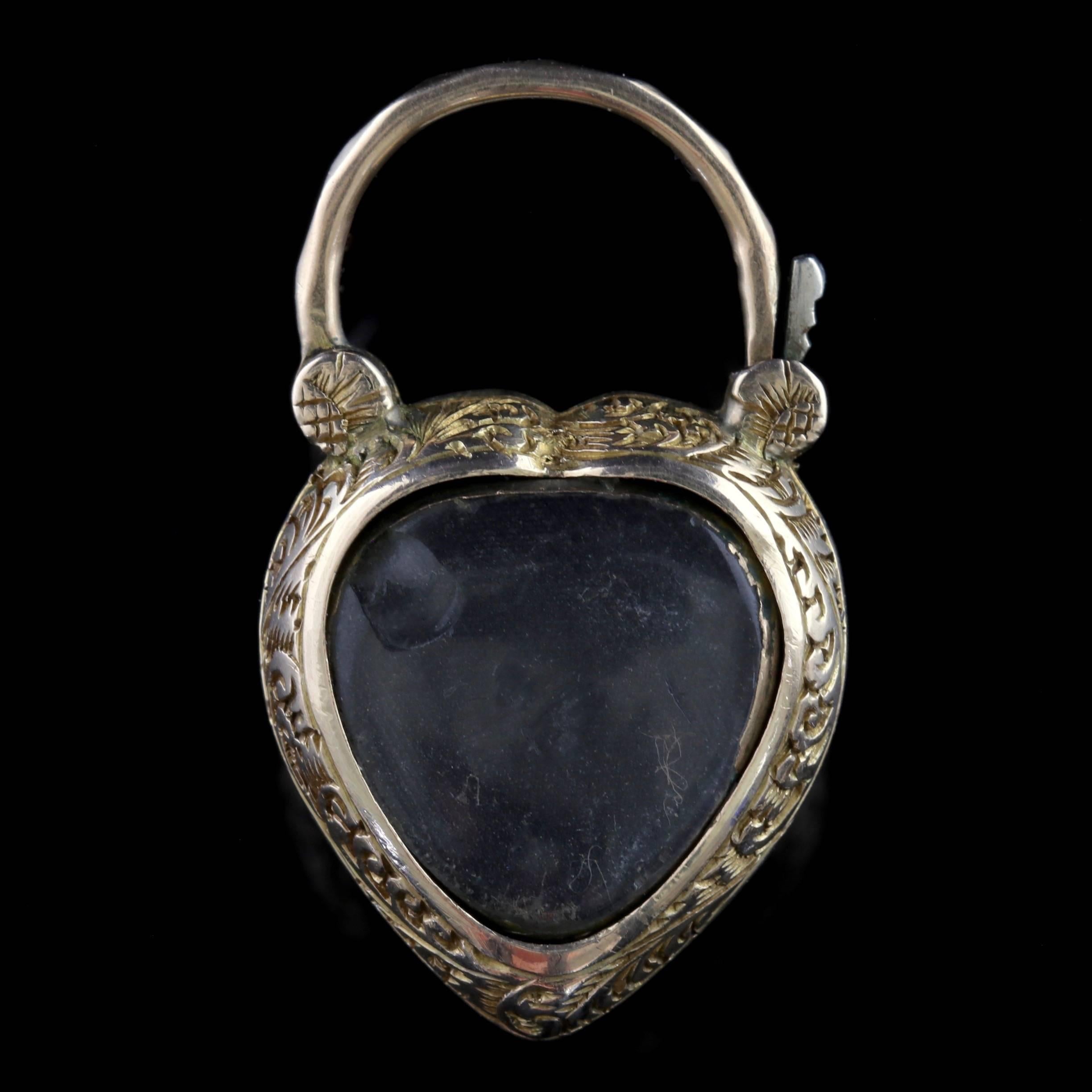 To read more please click continue reading below-

This lovely antique 18ct Gold padlock heart pendant is Victorian Circa 1900. 

The wonderful padlock style pendant is shaped like a heart and boasts a large deep red Cabochon Garnet in the centre.