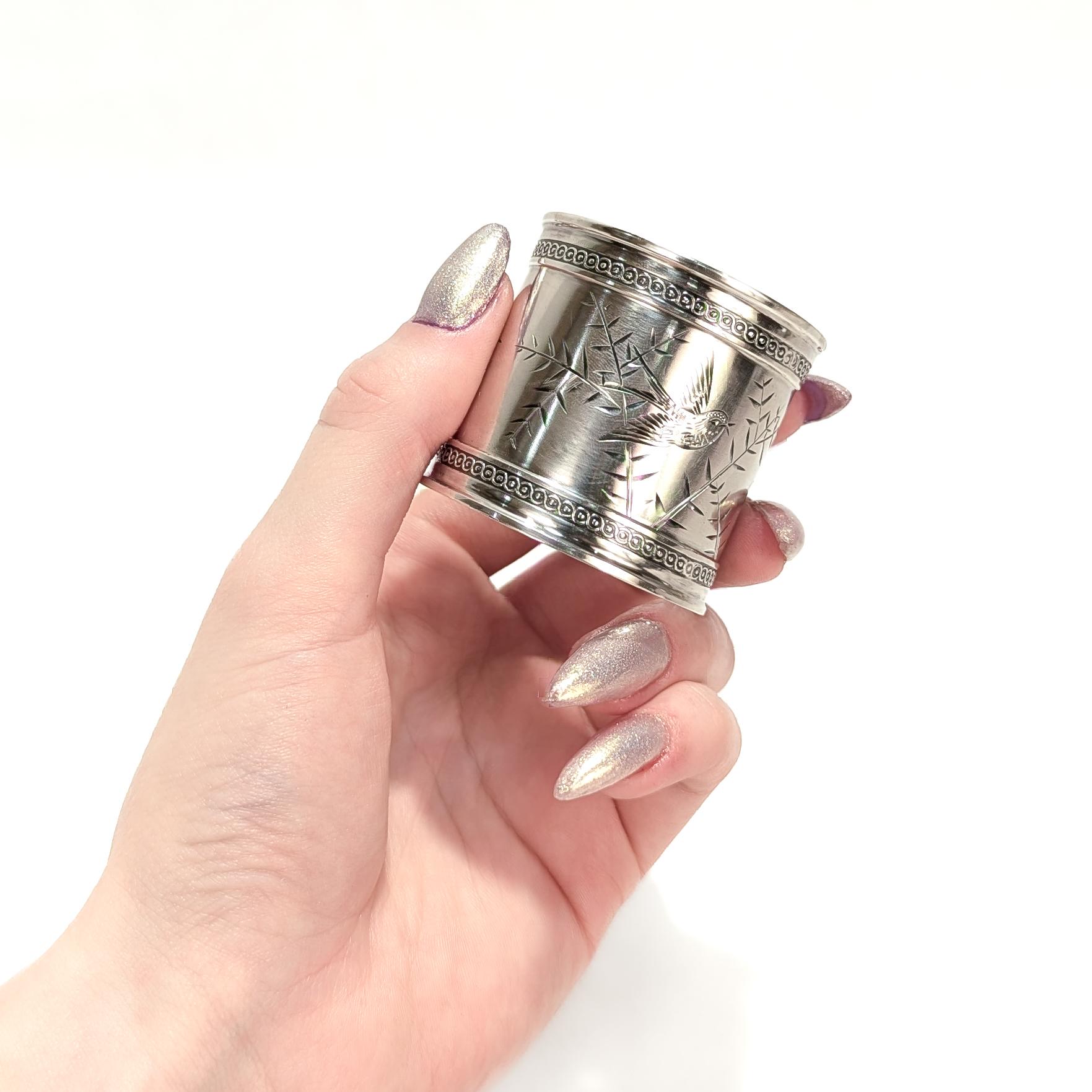 A fine antique Victorian silver napkin ring.

In a heavy-gauged sterling silver.

With engraved bird & branch decoration to the center with raised decoration to the rims.

Engraved in cursive script for 