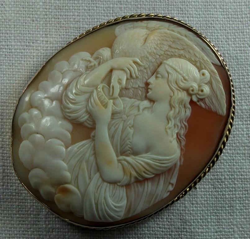 Museum quality shell cameo brooch depicting Hebe feeding the Eagle of Zeus. This cameo is a triumph of grace and delicacy. Everything in this piece speaks about art and the carver who made this work was just a true artist. Look at the beauty of