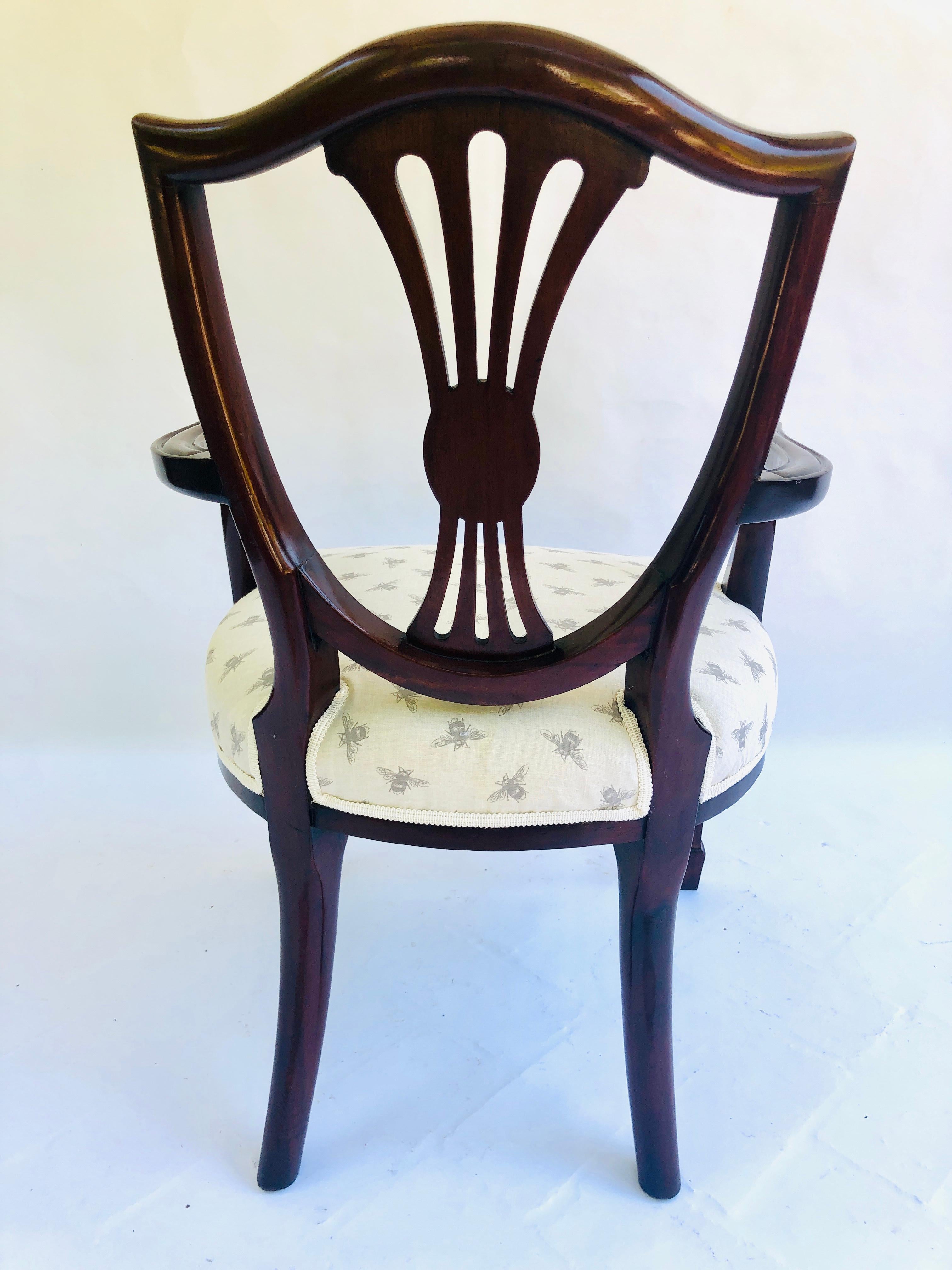 Antique Victorian Hepplewhite style mahogany armchair having an attractively designed carved shield back with a shaped pierced splat. Elegant swept open arms standing on square tapering legs with spade feet to the front and outswept legs to the