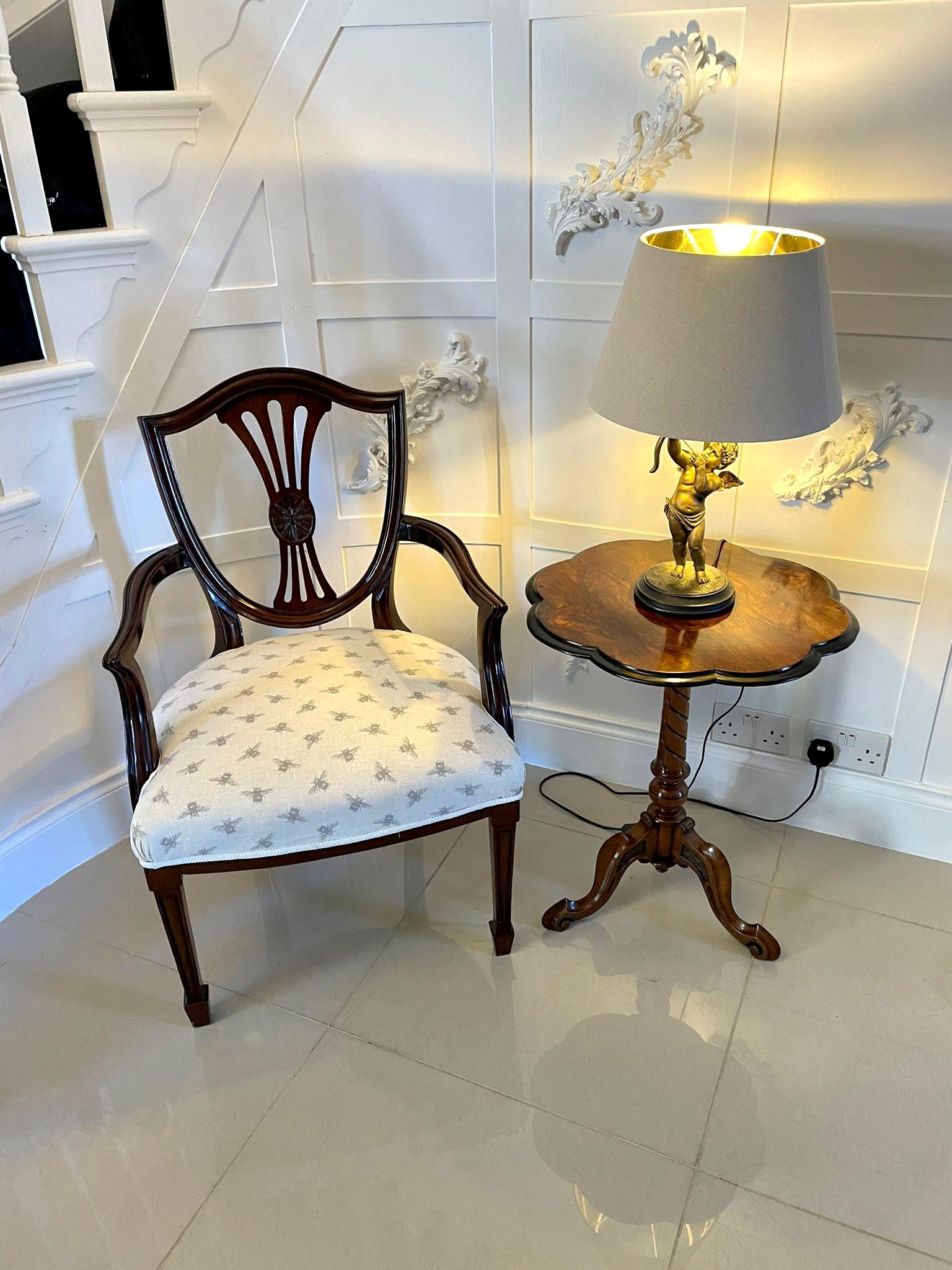 Antique Victorian Hepplewhite style mahogany armchair having an attractively designed carved shield back with a shaped pierced splat. Elegant swept open arms standing on square tapering legs with spade feet to the front and outswept legs to the