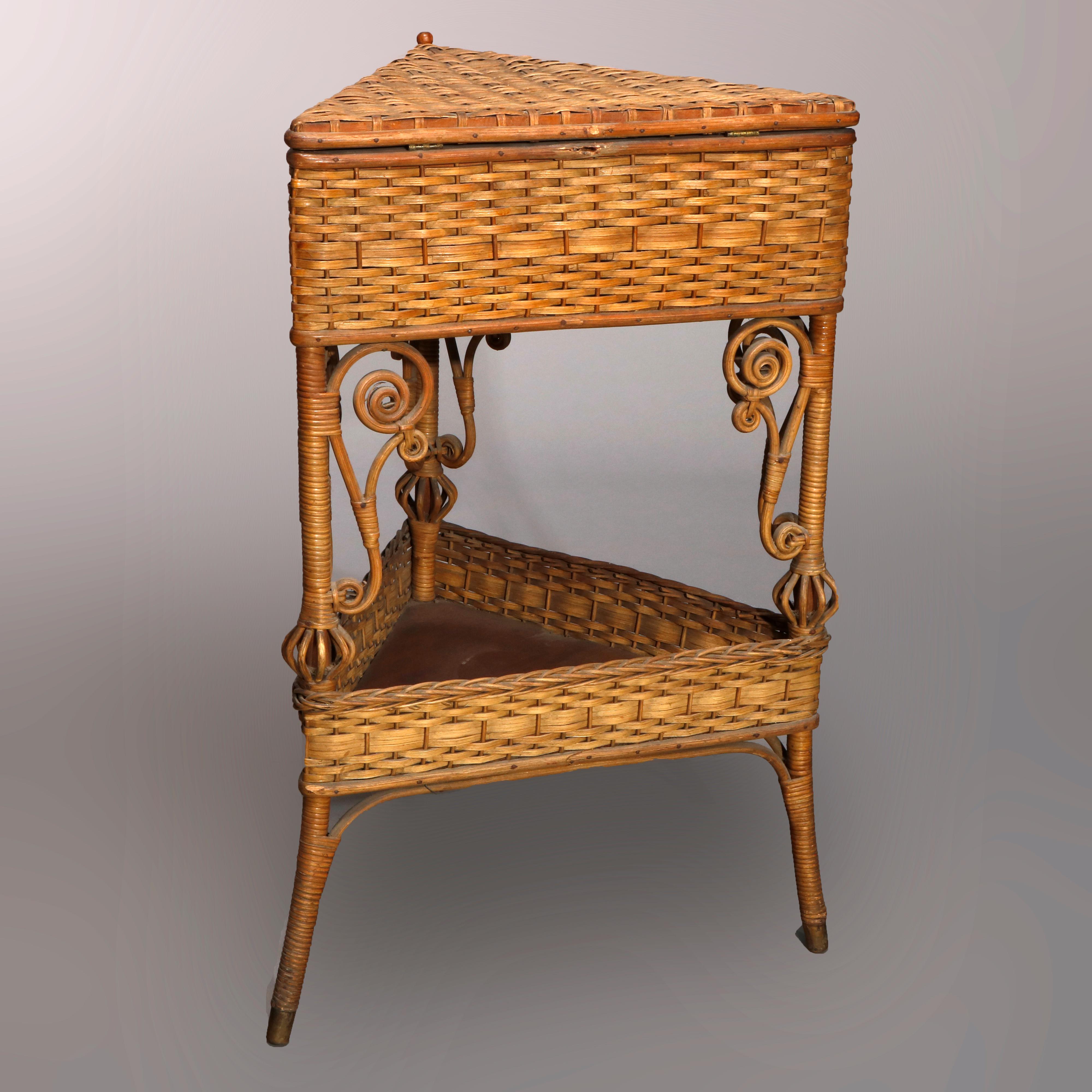 An antique Victorian corner sewing stand by Heywood Wakefield offers triangular form with wicker upper case having hinged lid surmounting lower tray raised on legs with scroll form corbels, circa 1890

Measures- 28.25
