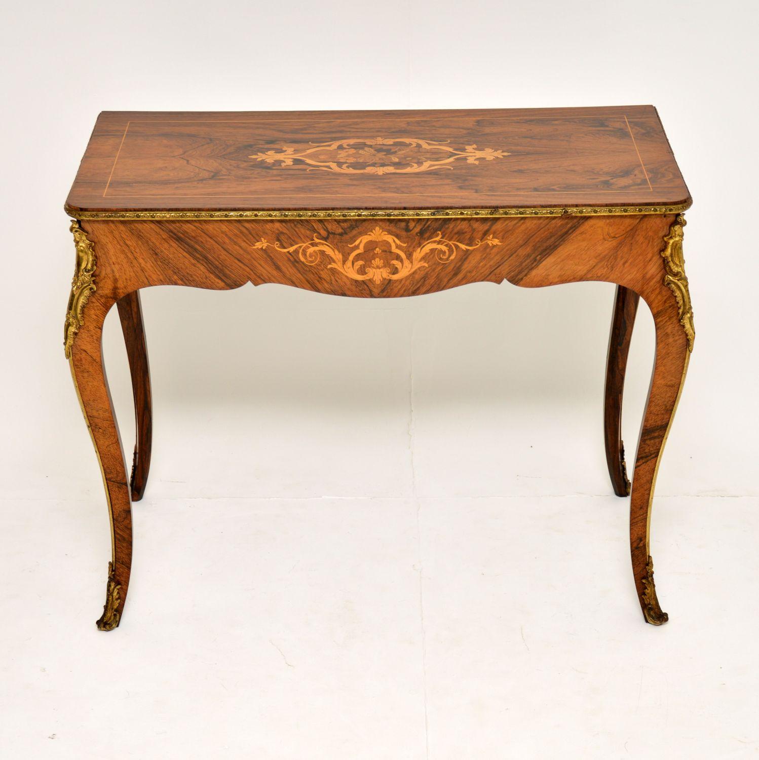 Fine quality antique Victorian console side table dating from circa 1860s period, in very good condition, with loads of character and a lovely original color.

It has some exquisite marquetry of many different exotic woods. The marquetry