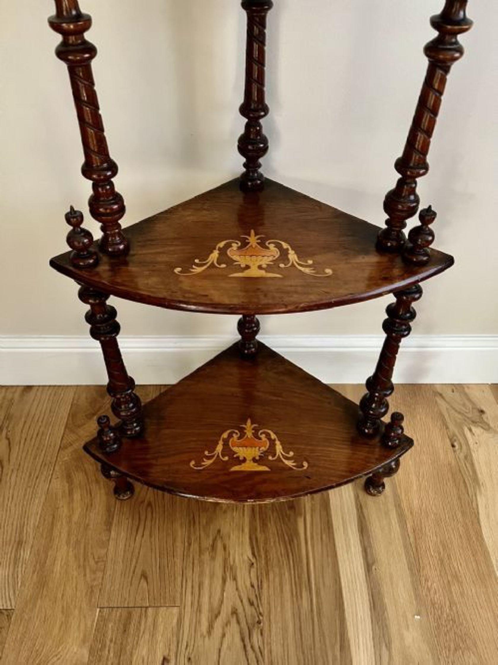 Antique Victorian inlaid figured walnut corner whatnot having a four tier inlaid figured walnut corner whatnot with turned tapering supports, original turned feet and a carved shaped gallery top