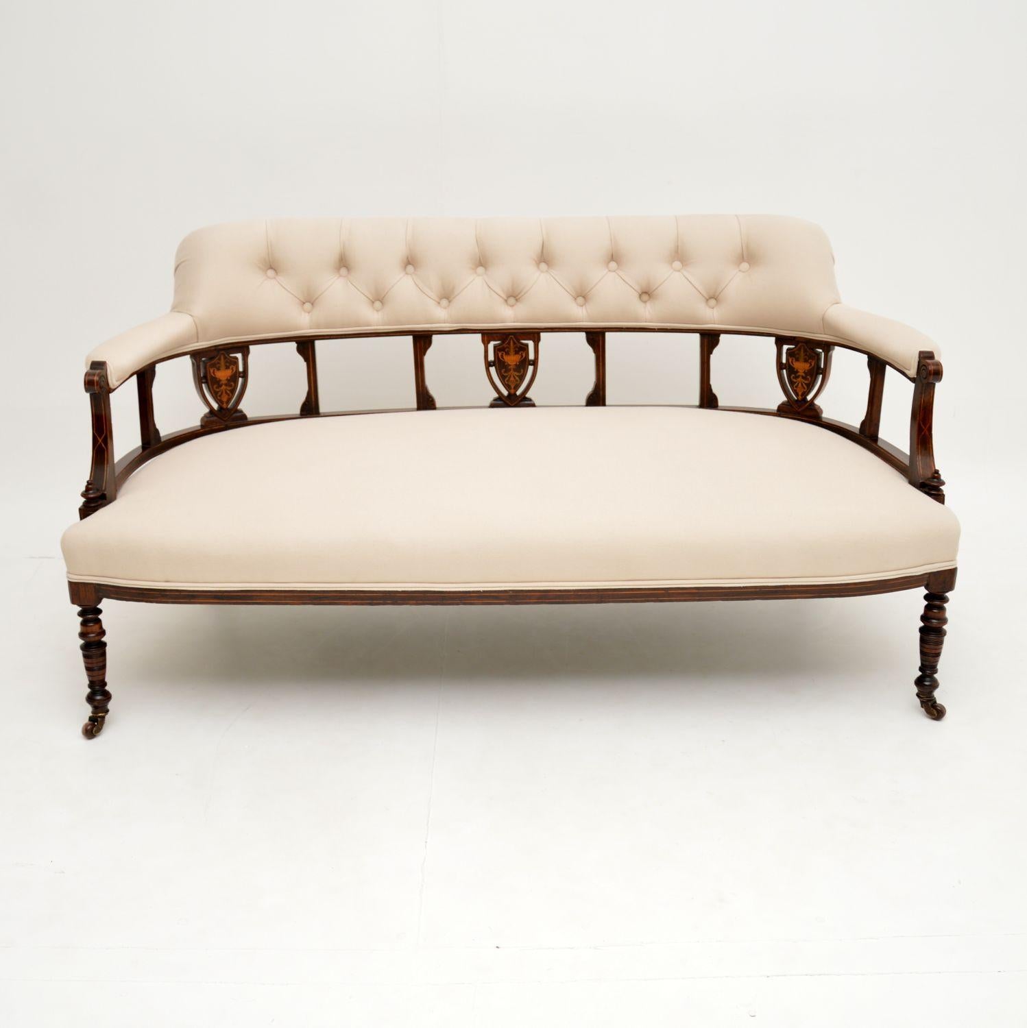 A stunning antique settee dating from the 1890-1900 period. This is finely made from solid wood, with beautiful satin wood inlays.

It is well built, sturdy and sound, it sits on beautifully turned legs terminating in original porcelain