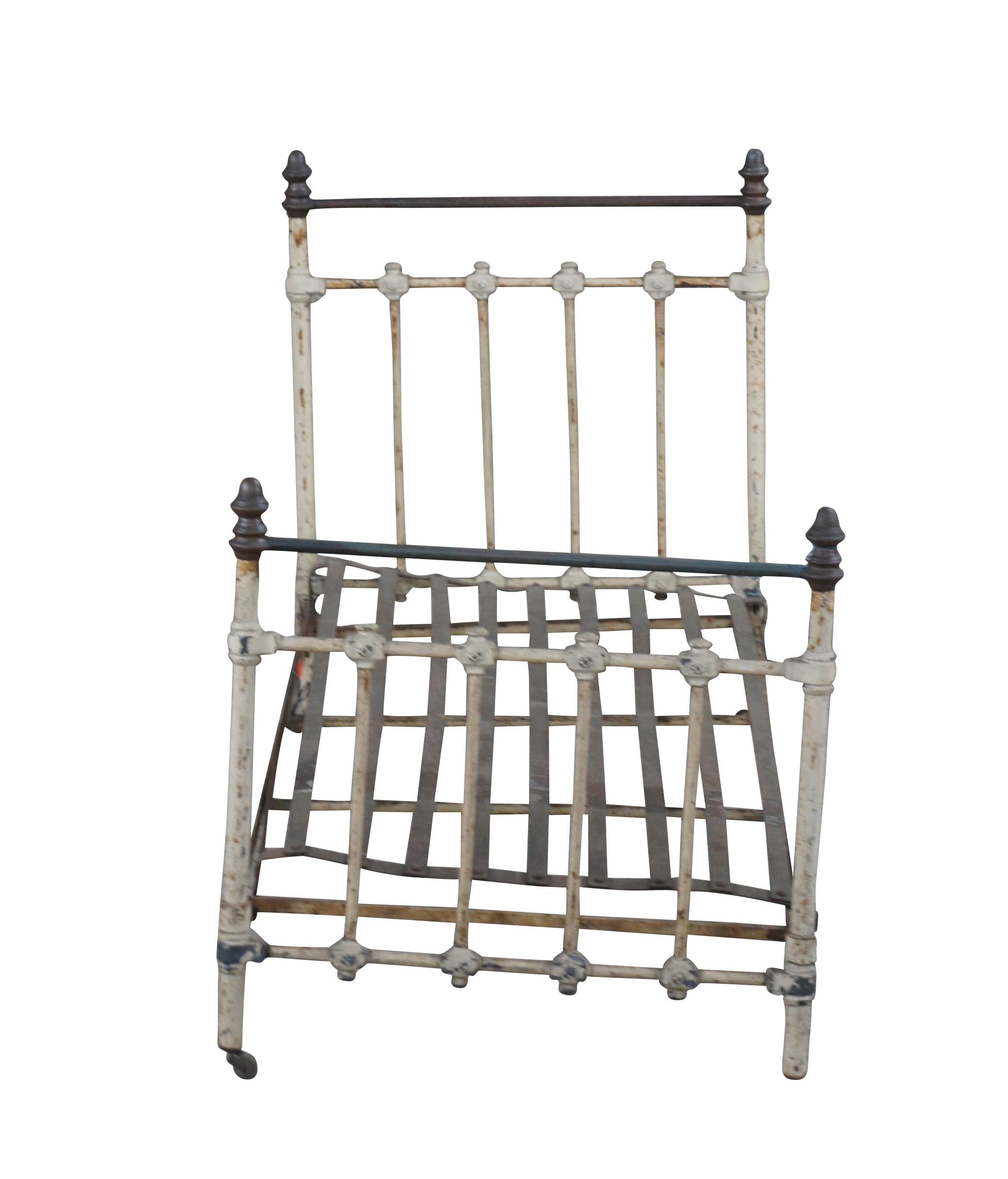 An antique Victorian Salesman Sample bed frame.  Made from iron with brass toppers.  

Antique salesman samples (a.k.a. salesman's samples, or salesmen samples) are small scale versions of actual commercial products that were used to sell a