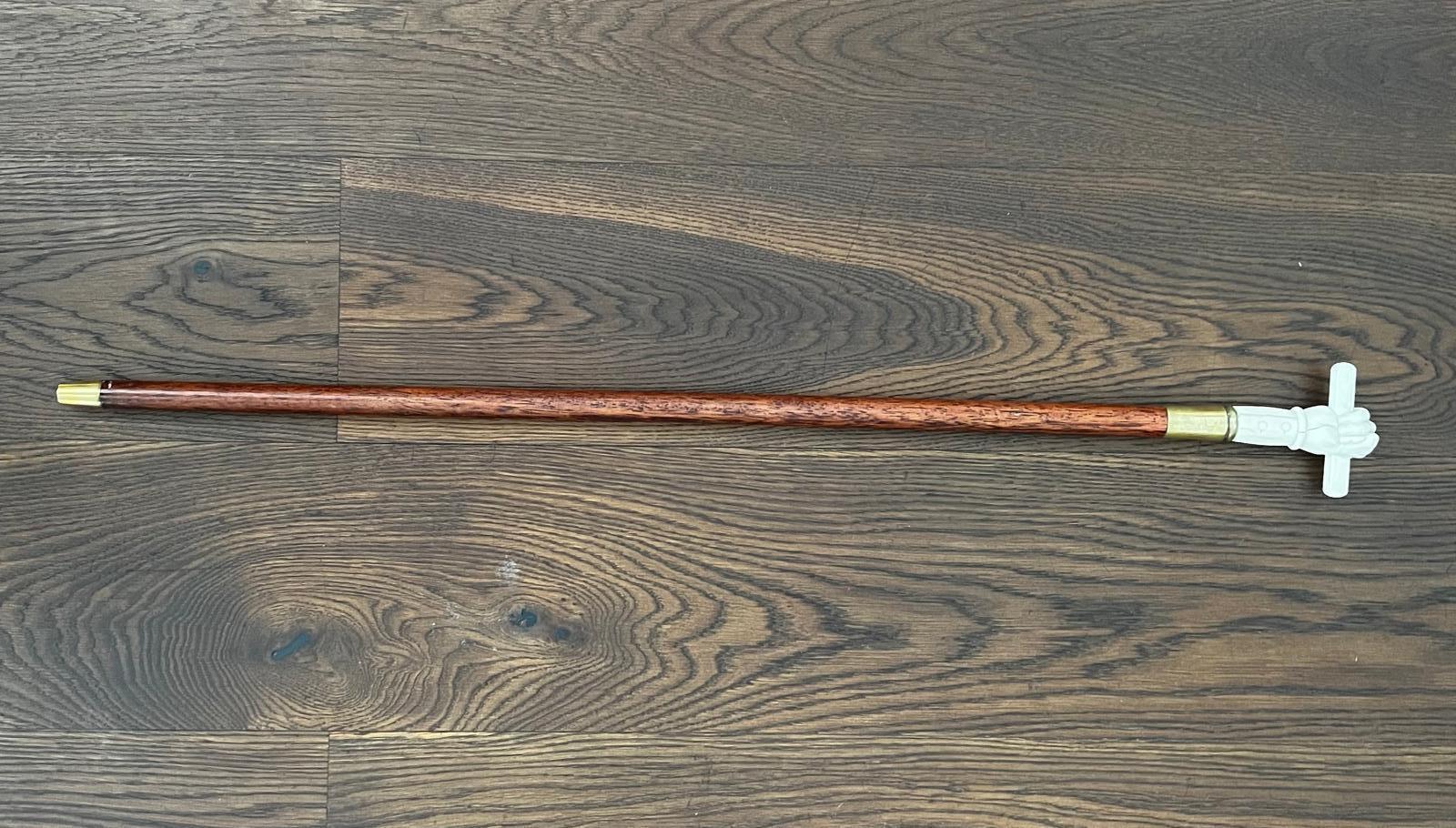A very rare unique example of British late Victorian 19th century Ivory and rosewood walking stick/cane. 
Carved Ivory clenched fist holding a removable scroll grip, the rest of the hand is bronze and has engraved personal initials on it - G.N.C.