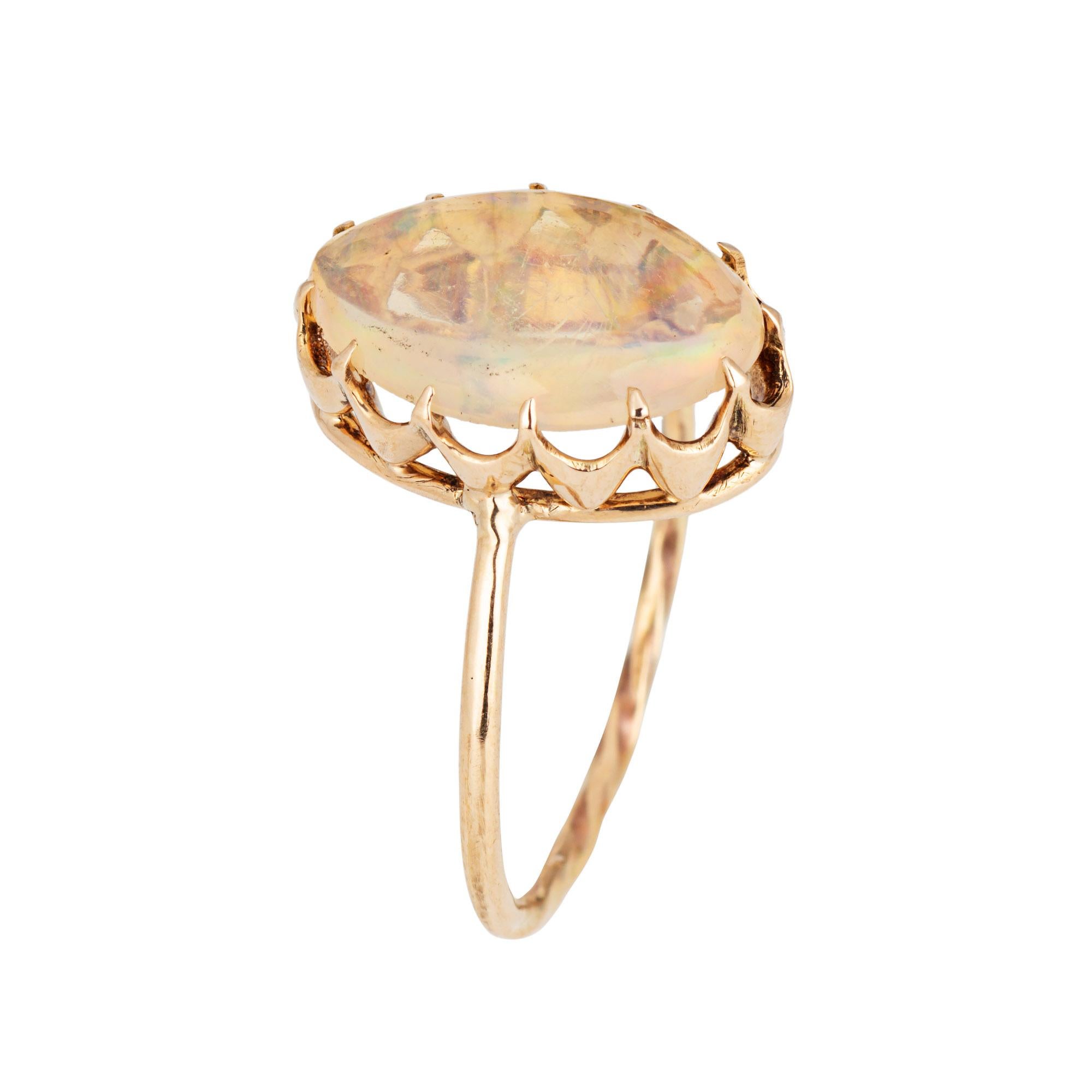 Originally an antique Victorian era stick pin (circa 1880s to 1900s), the jelly opal ring is crafted in 14 karat yellow gold.

The ring is mounted with the original stick pin. Our jeweler rounded the stick pin into a slim band for the finger. The