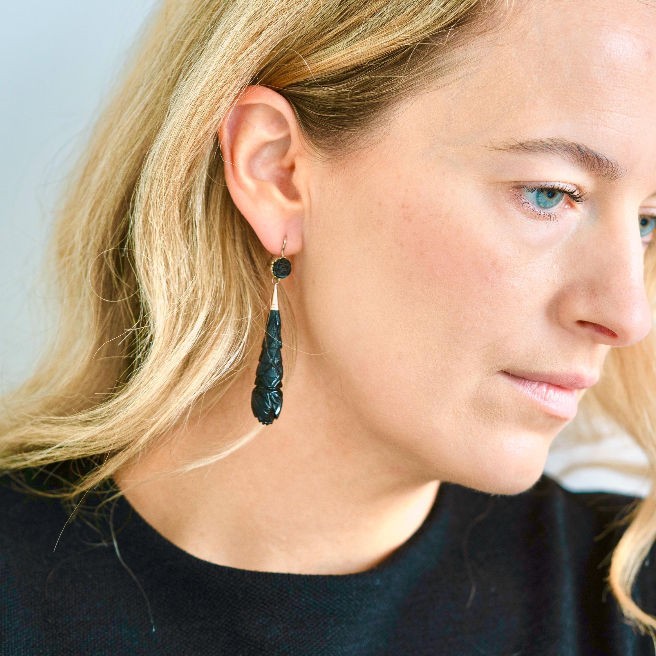 Antique Victorian mourning earrings featuring a hand carved drops. The drops feature roses for love and forget-me-not representing remembrance. The earrings are set 9ct gold. 

Jet is fossilised wood from an area in England called Whitby. This