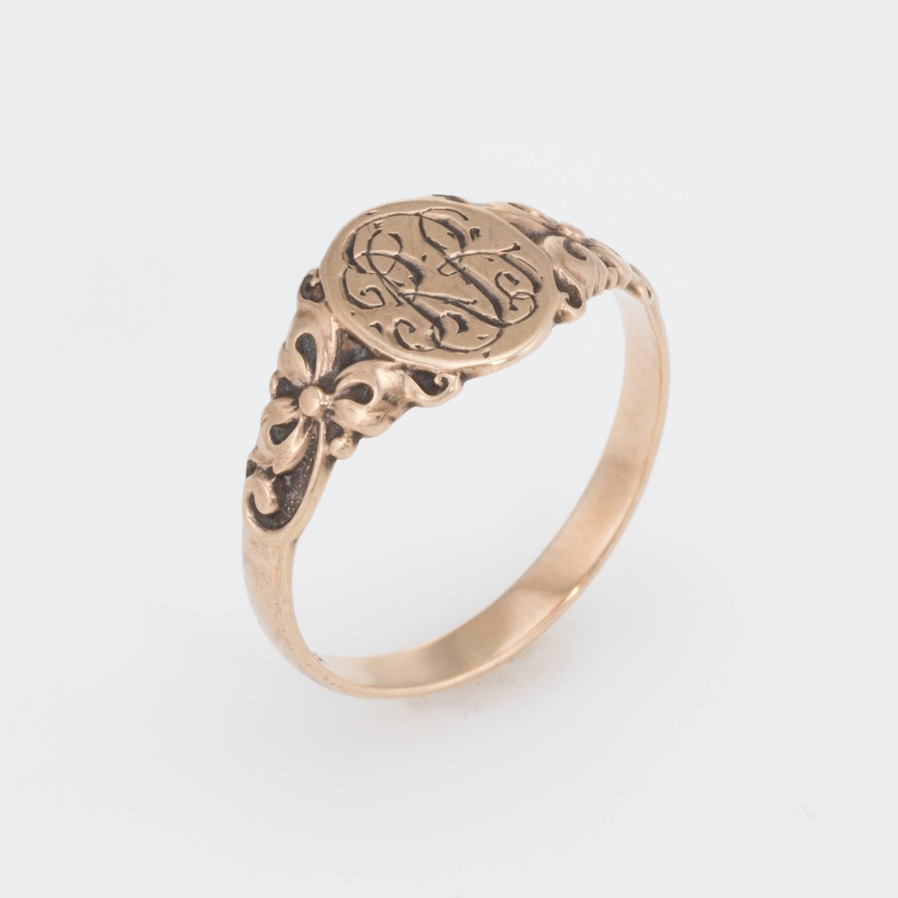 Elegant antique Victorian ring (circa 1880s to 1900s), crafted in 10 karat rose gold. 

The oval signet is inscribed with the letters (from what we can decipher) 