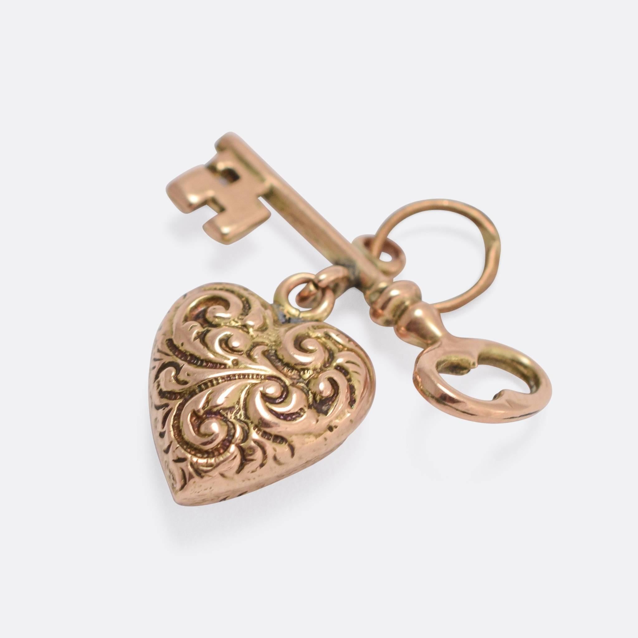 An adorable antique sentimental pendant, modelled as a key and chased heart. It's fully articulated, the two component parts hanging from a jump ring, and crafted from 9k gold throughout. The sentiment can be read as 