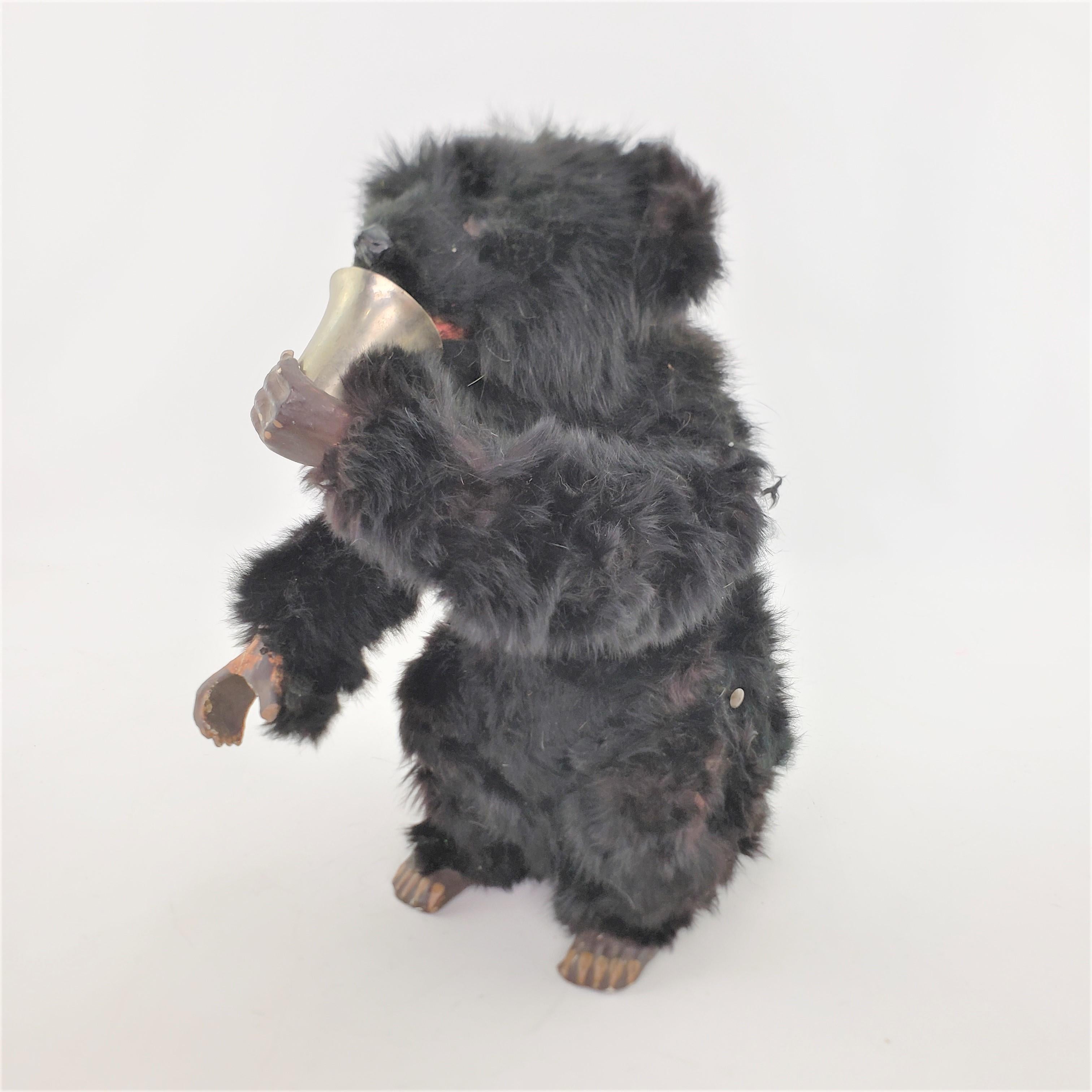 This antique mechanical toy is unsigned, but presumed to have been made in Europe, possibly England or Austria in approximately 1880 and done in the period Victorian style. This large toy is a black bear with articulated arms and mouth. The