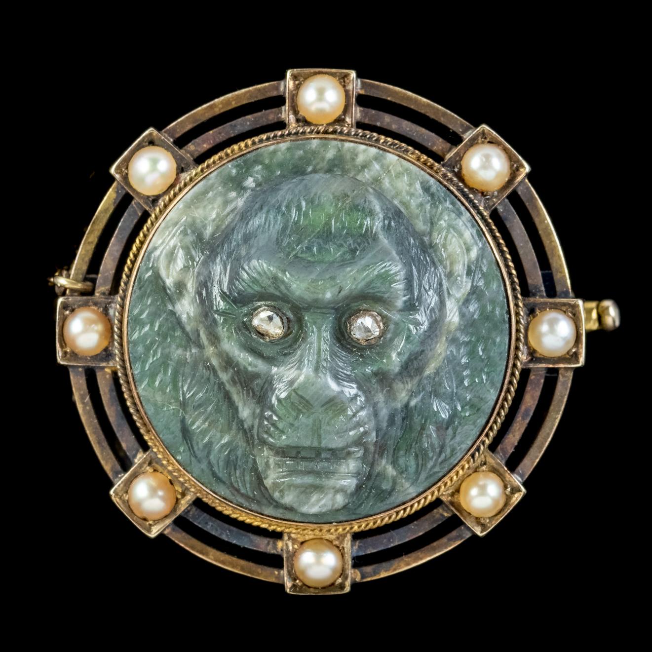 A fascinating Antique mid Victorian brooch featuring a wonderful hand carved Labradorite monkey face set with Rose cut Diamond eyes. The Labradorite is a well-executed carving, with high relief workmanship showing shape and characteristics in the